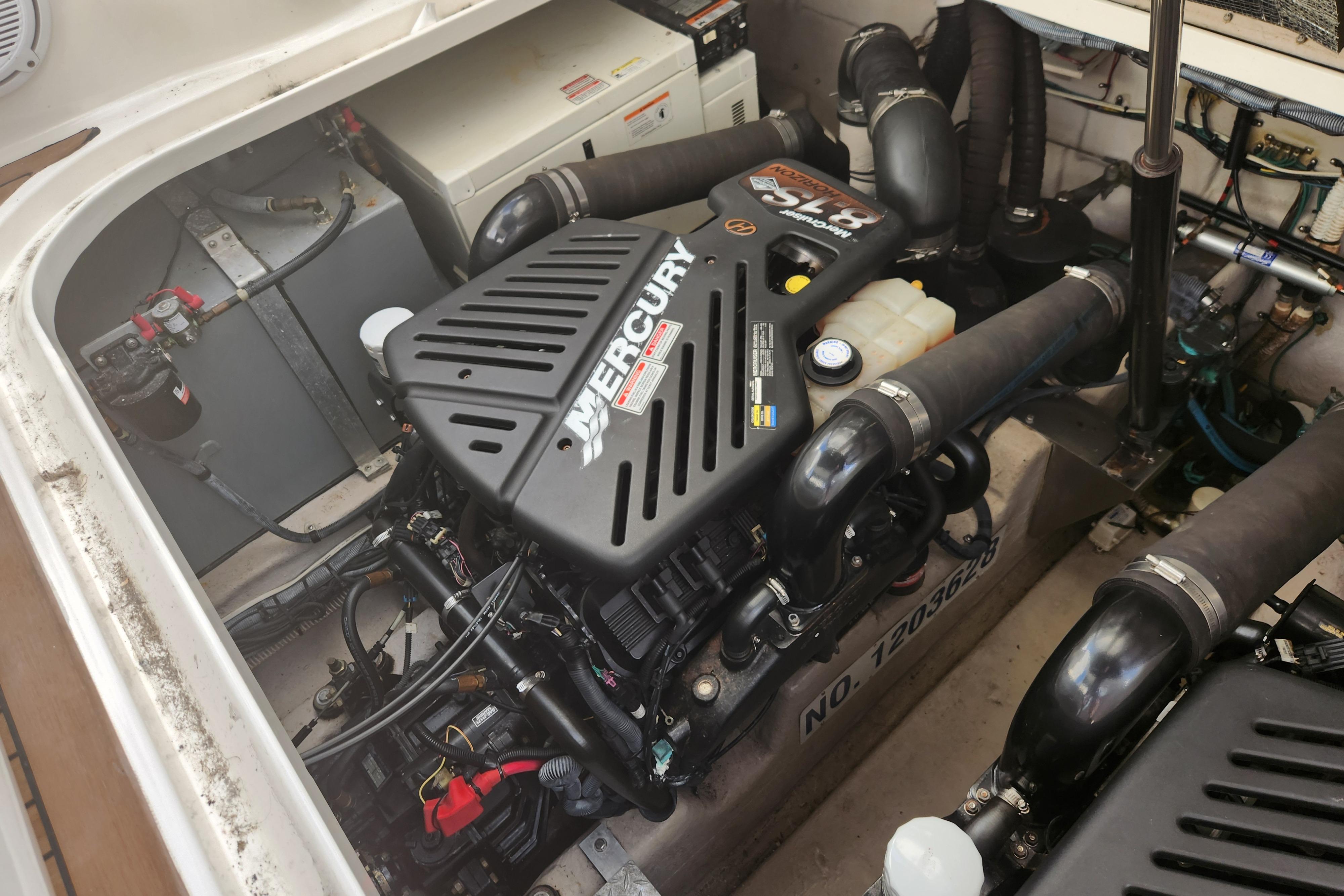 Engine compartment of a 2003 Sea Ray 360 Sundancer with Mercury engine components.