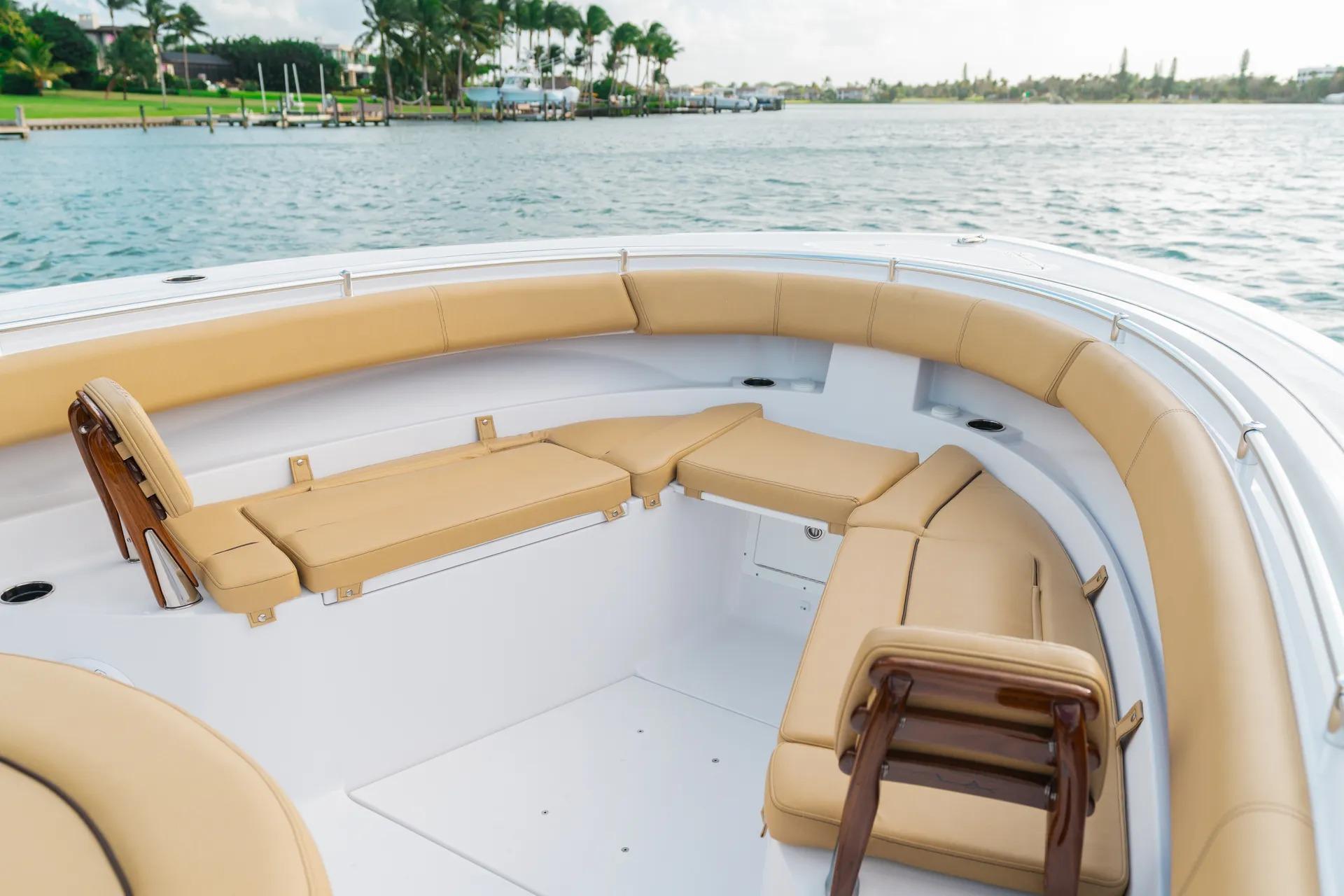 2026 Sportsman Open 352 Center Console boat with tan seating, docked on calm water.