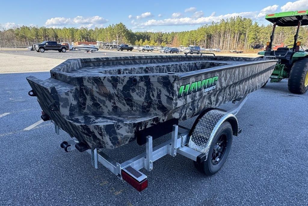 2025 Havoc 1860 boat with camouflage design on a trailer in a parking lot.