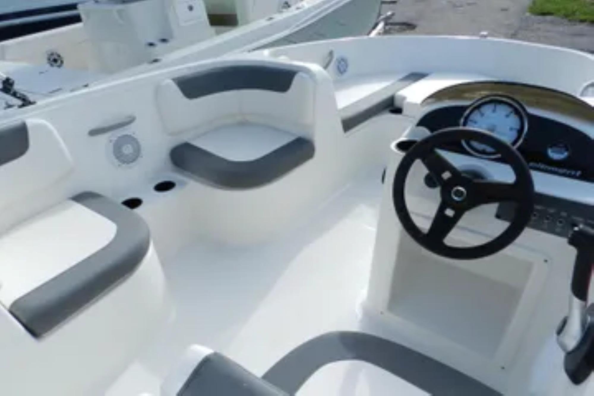 2026 Bayliner Element E18 boat interior with steering wheel and seating.