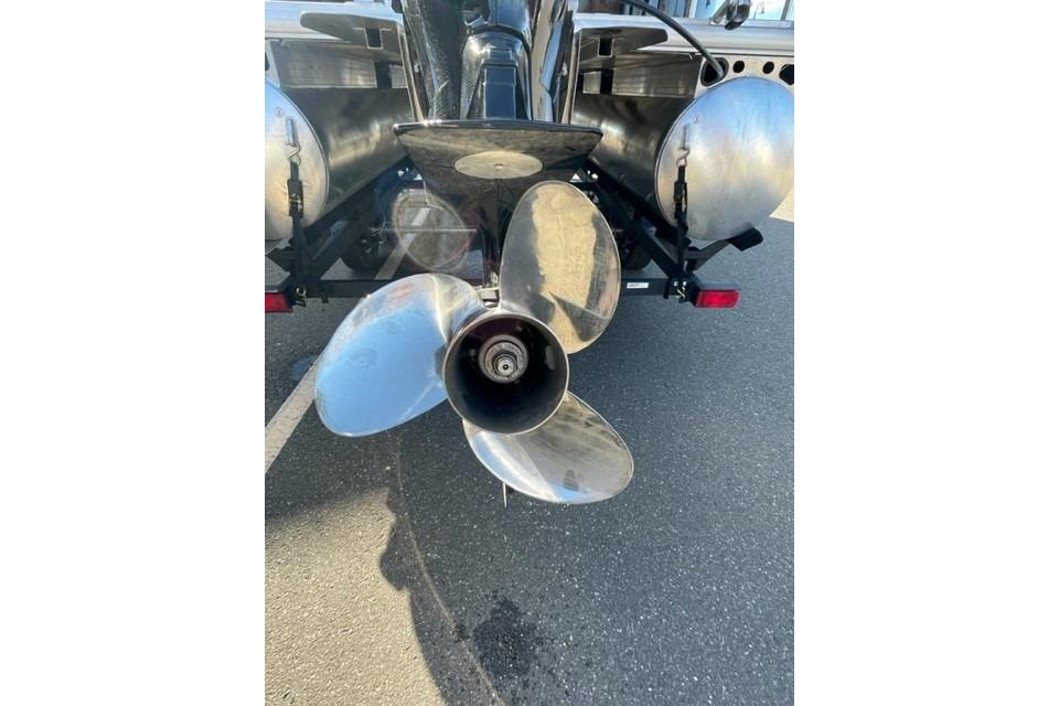 2026 Sun Tracker Party Barge 22 DLX propeller close-up on pavement.