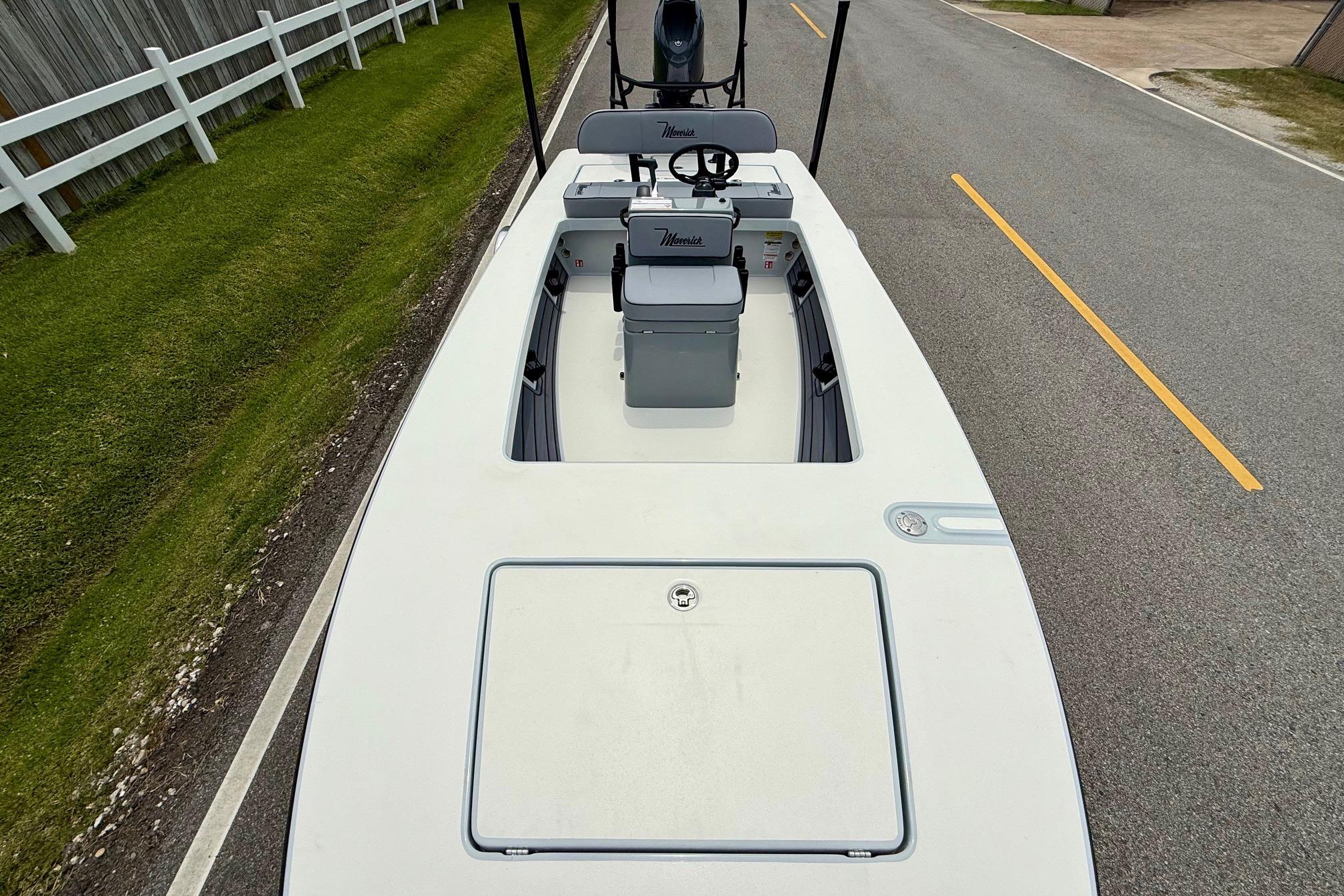 2026 Maverick 17 HPX-S boat on road, top view, near white fence.