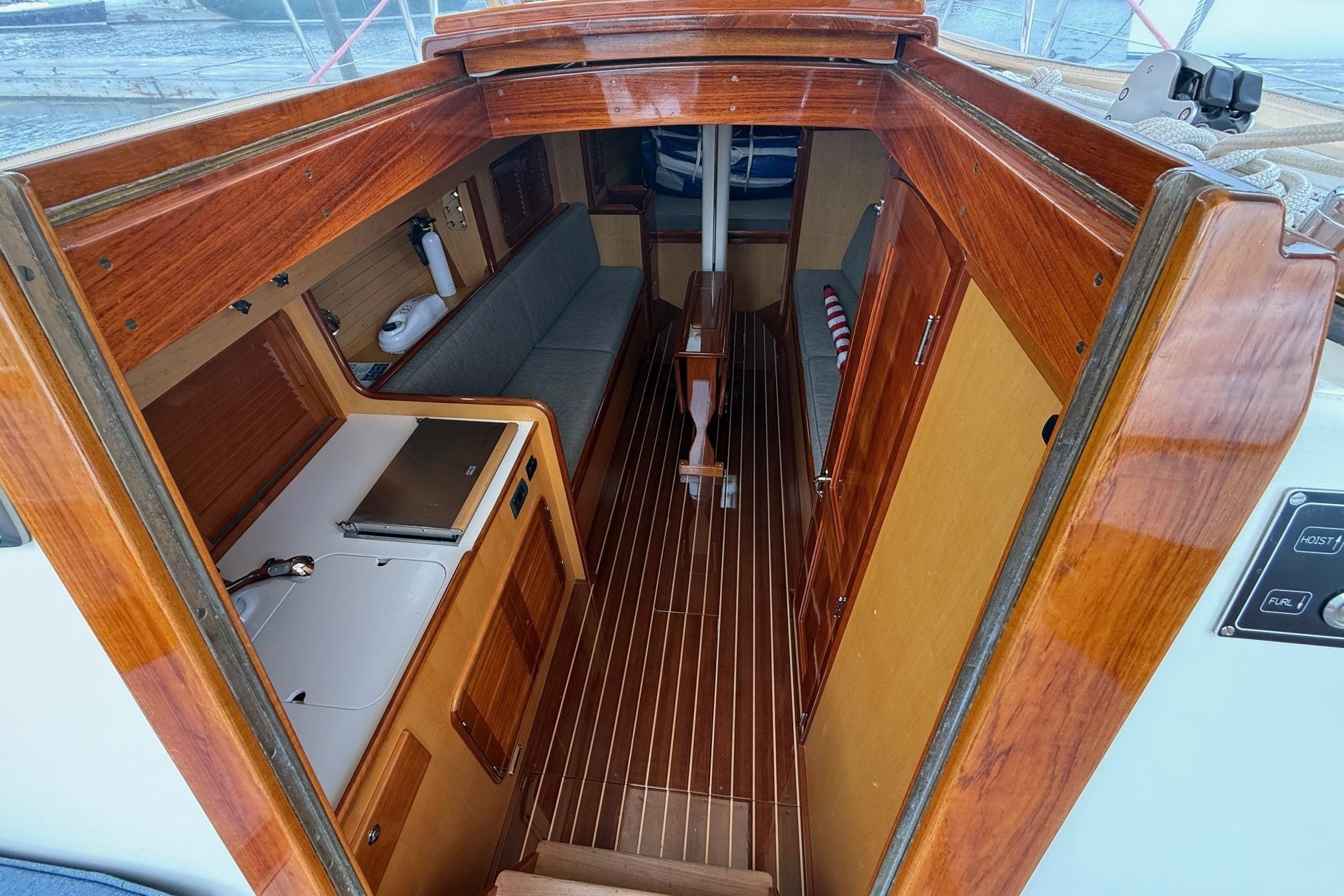 Interior of 2015 Hinckley DS 42 sailboat with wooden finishes and compact layout.