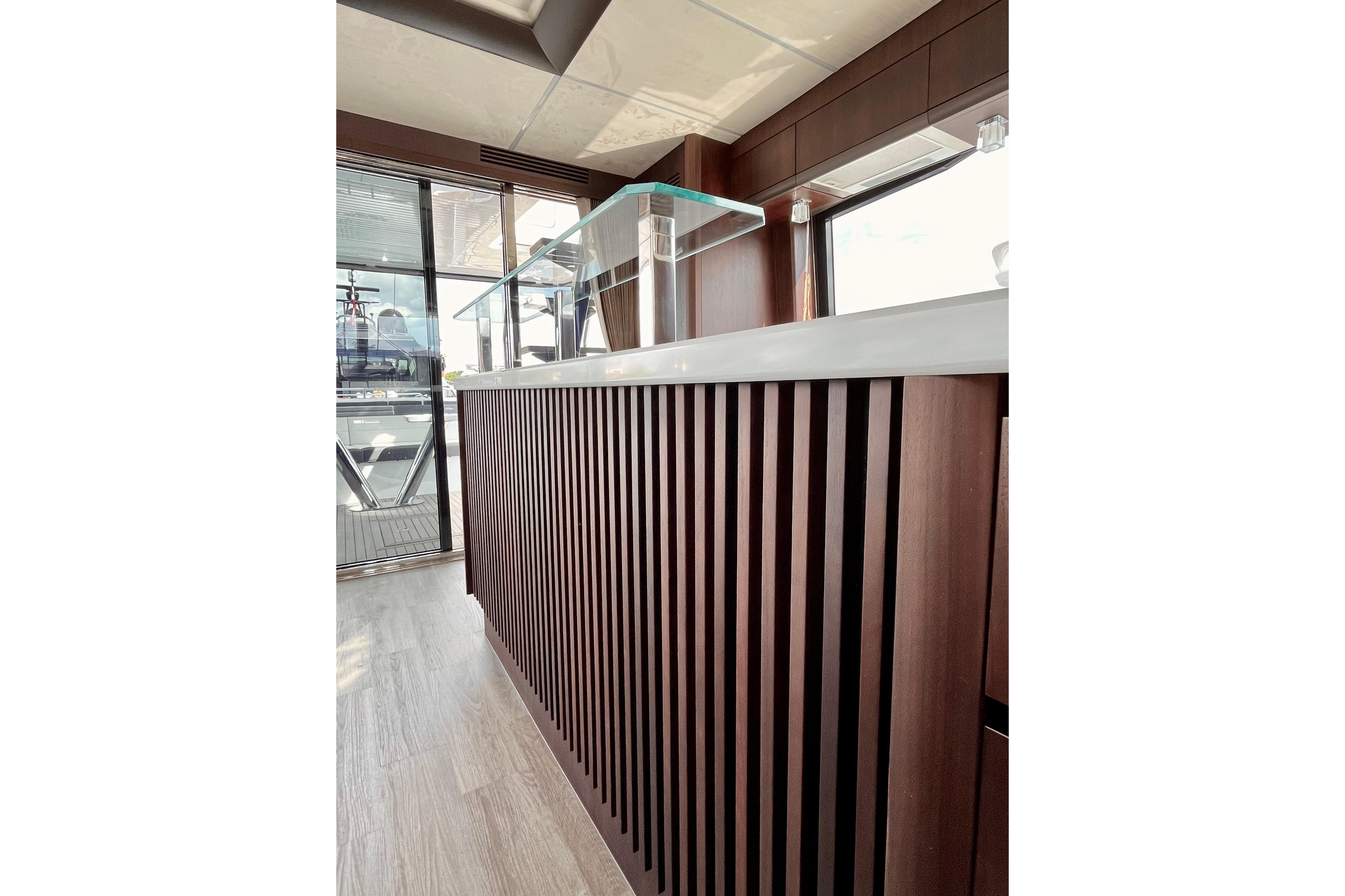 Luxurious interior of 2025 Galeon 700 Sky yacht with sleek wooden paneling.
