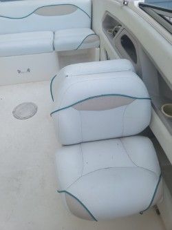 Interior of a 1996 Wellcraft 2400S boat with white seating.