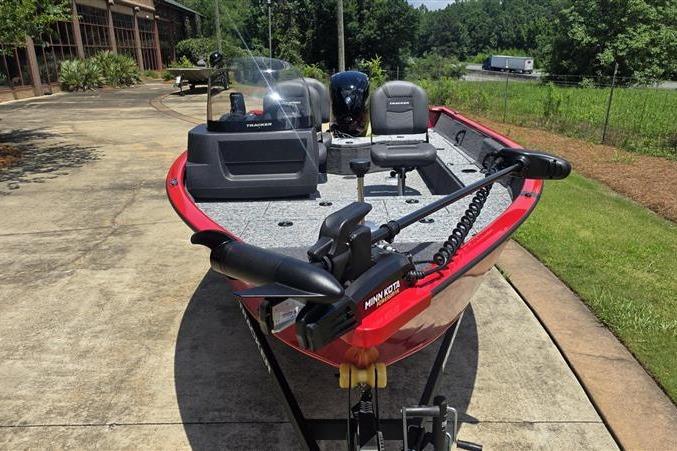 2026 Tracker Pro Guide V-16 SC fishing boat on a driveway, featuring a Minn Kota trolling motor.