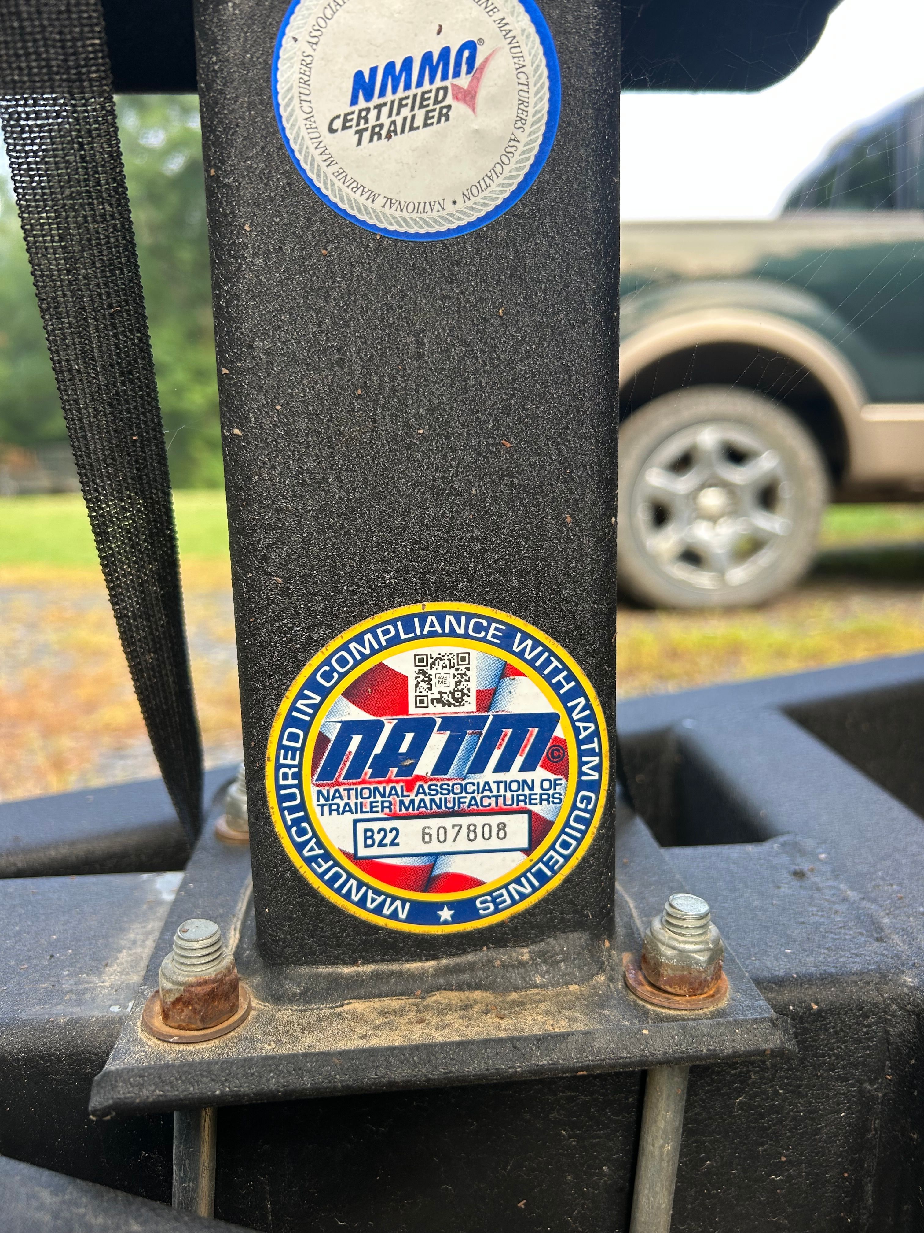 Stickers on a trailer with NATM and NMMA certifications.