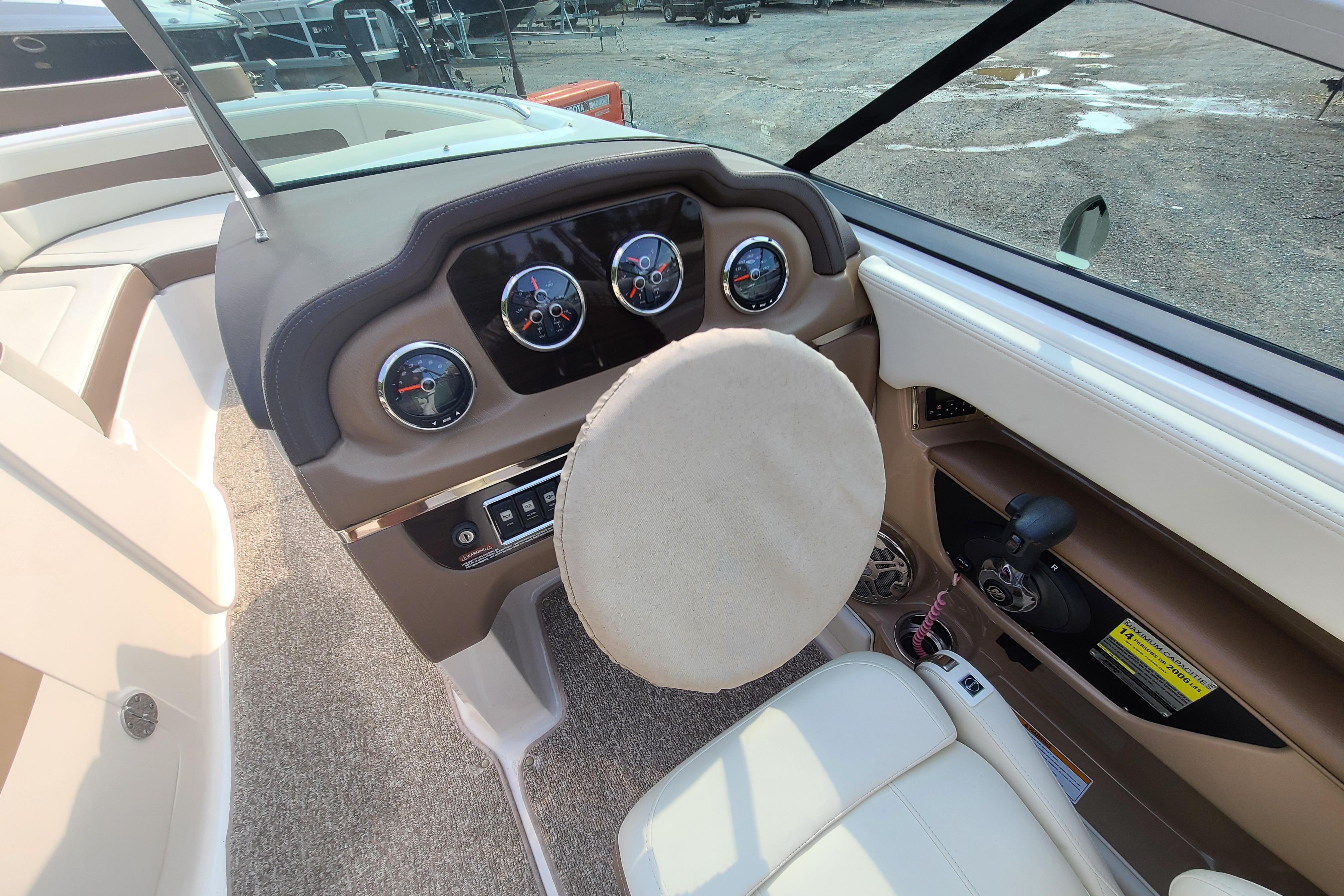 Interior view of 2014 Chaparral 246 SSi boat dashboard and steering wheel.