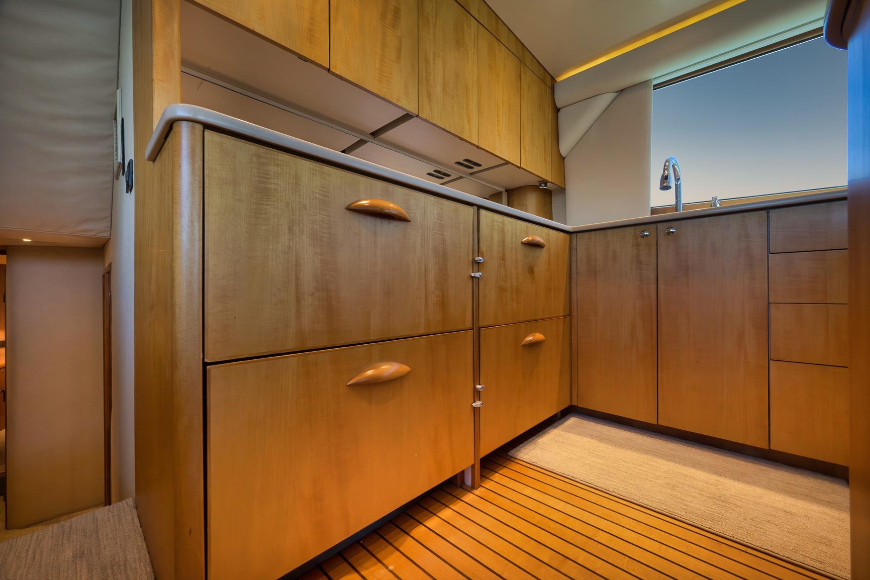 Luxurious wooden cabinetry in 2003 Weaver Custom Sportfish yacht kitchen interior.