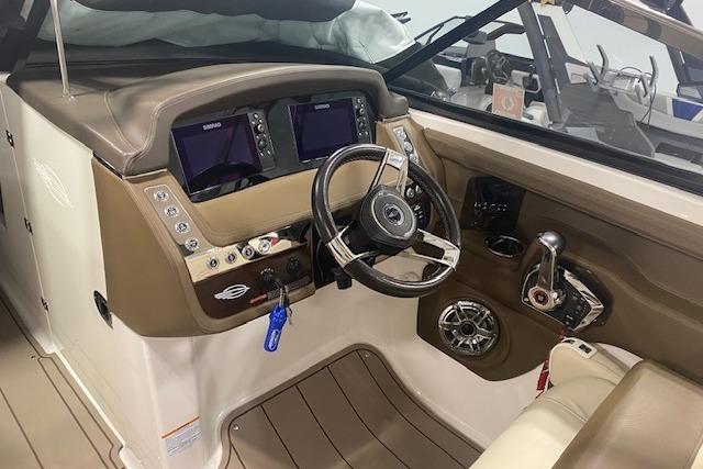 2023 Chaparral 307 SSX boat cockpit with dual displays and steering wheel.