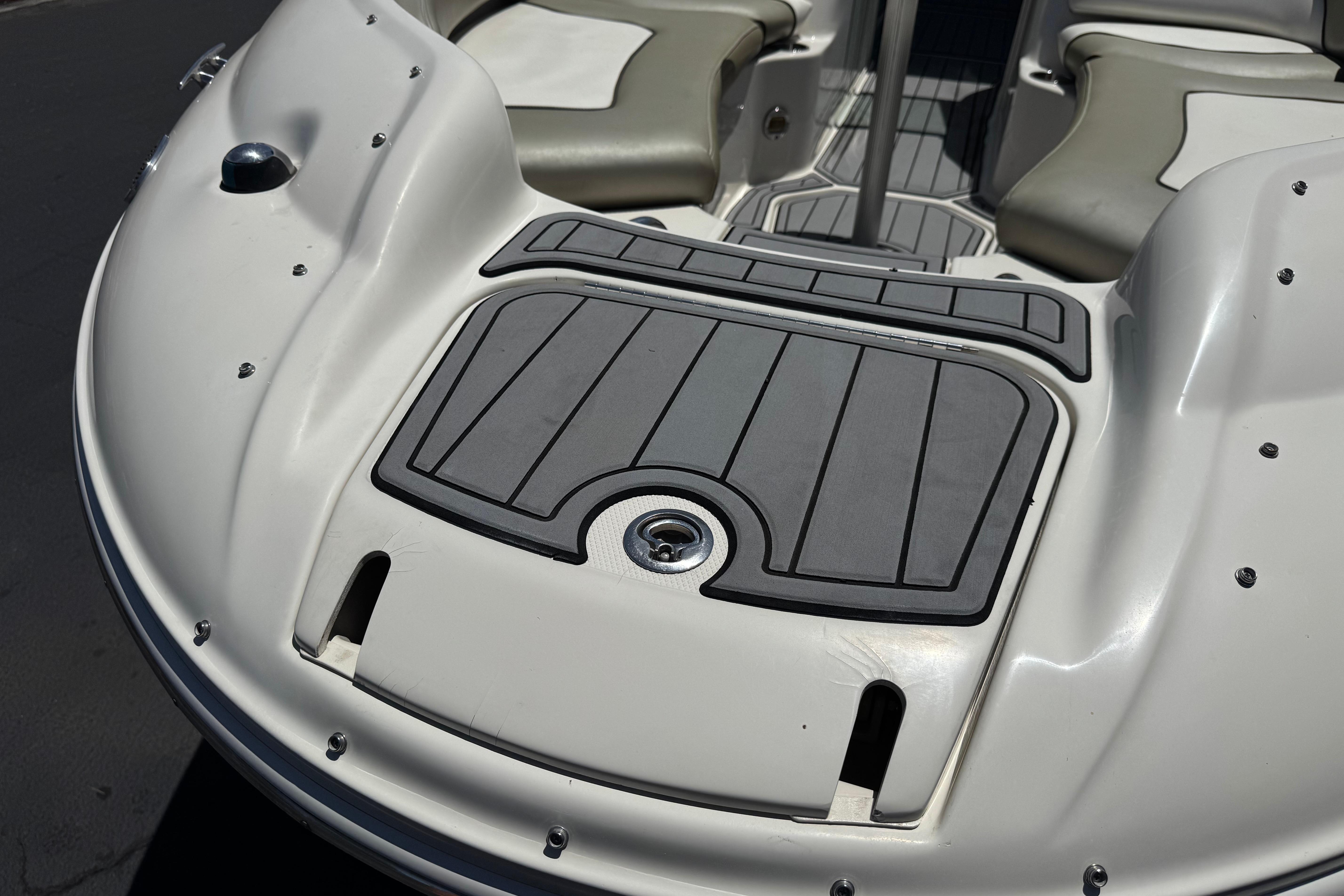 2007 Sea Ray 240 Sundeck boat interior with cushioned seating and non-slip flooring.