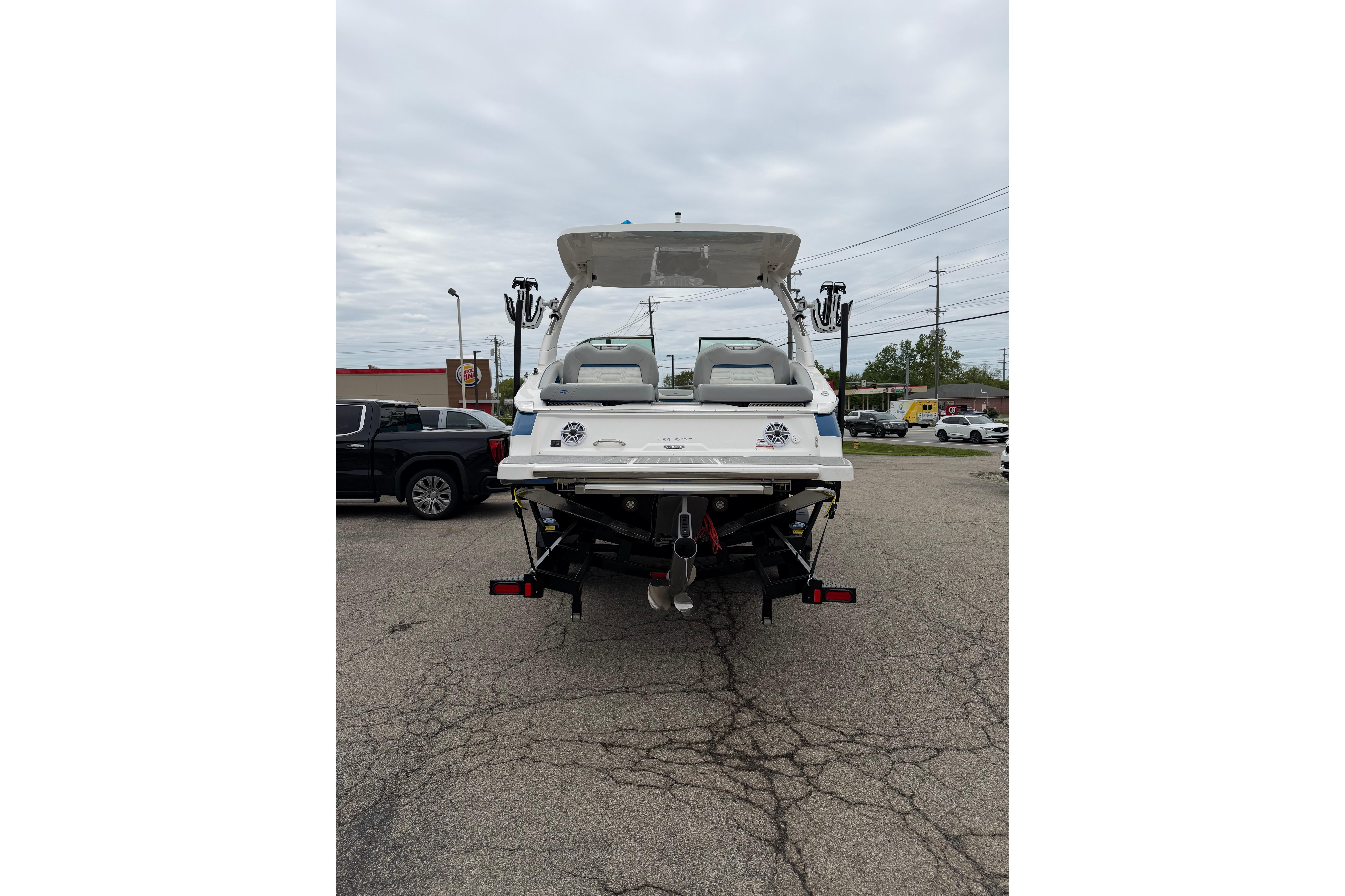 2026 Regal LS9 Surf boat on trailer, rear view in parking lot.