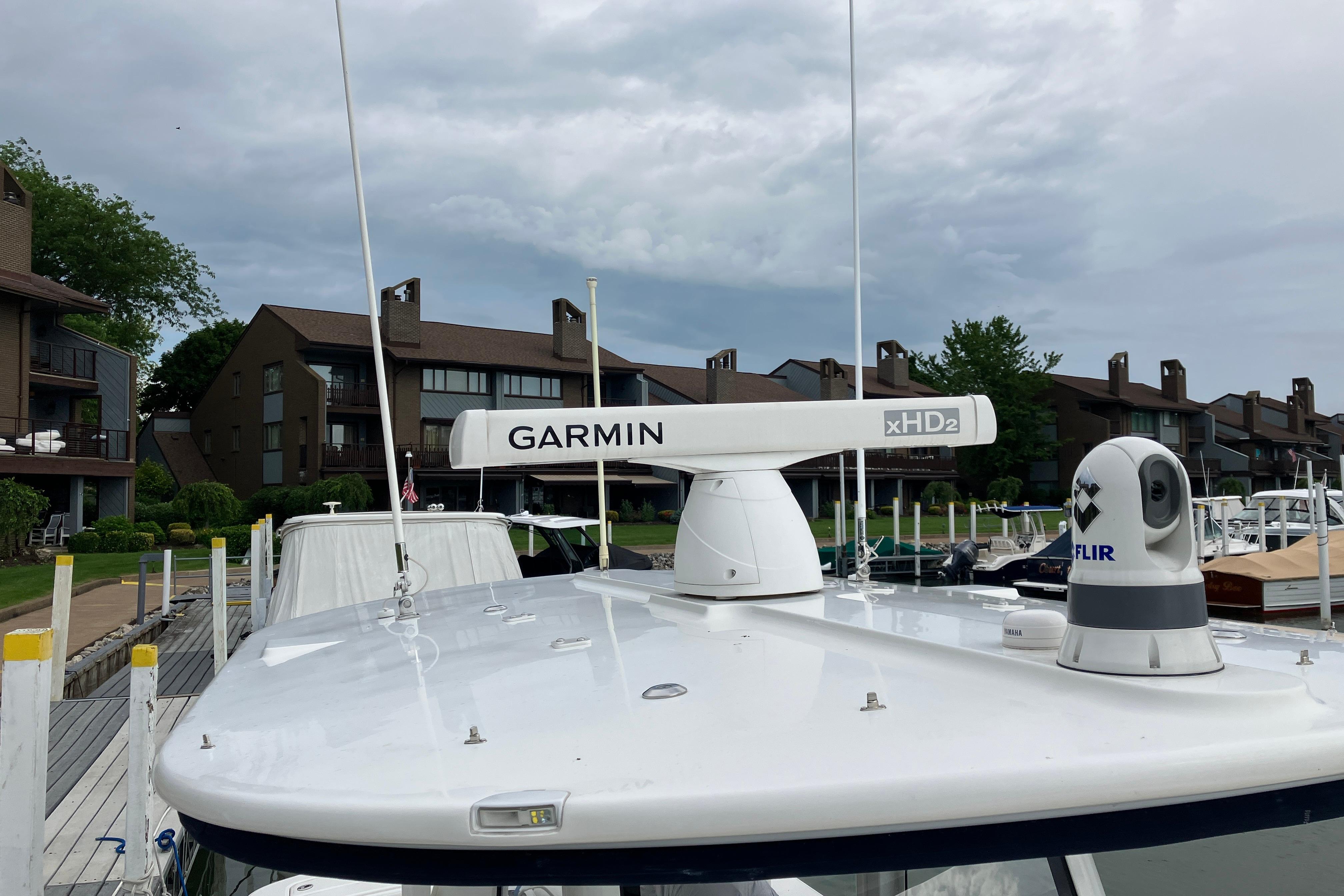 2021 Regulator 31 boat with Garmin xHD2 radar and FLIR camera at a marina.