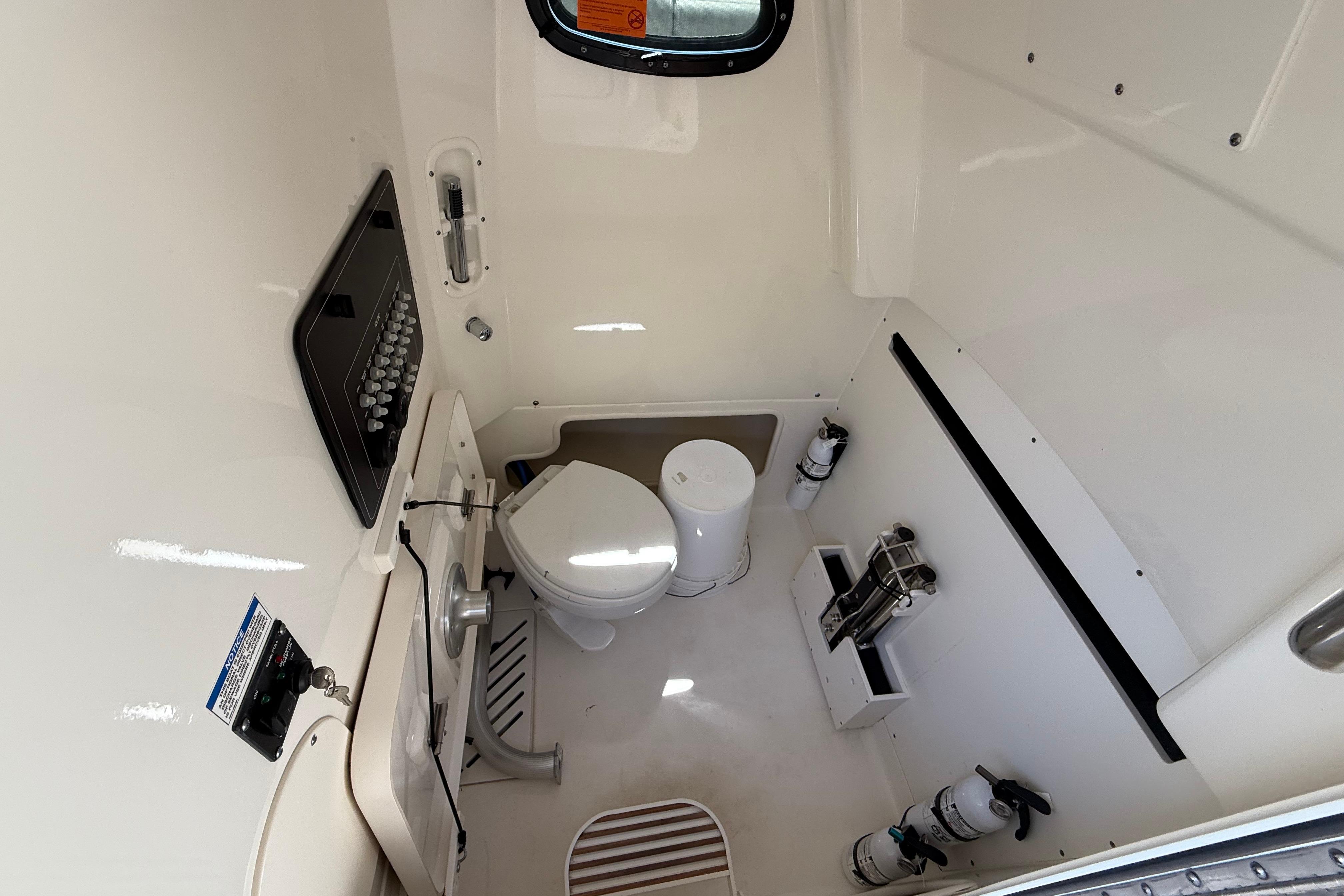 2024 Boston Whaler 280 Outrage cabin interior with toilet and sink.