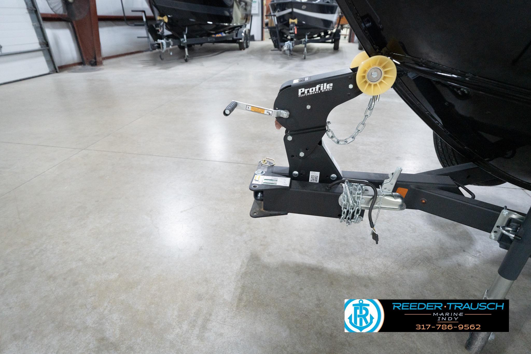 2026 Lund 1800 Explorer Sport boat trailer hitch in a showroom setting.
