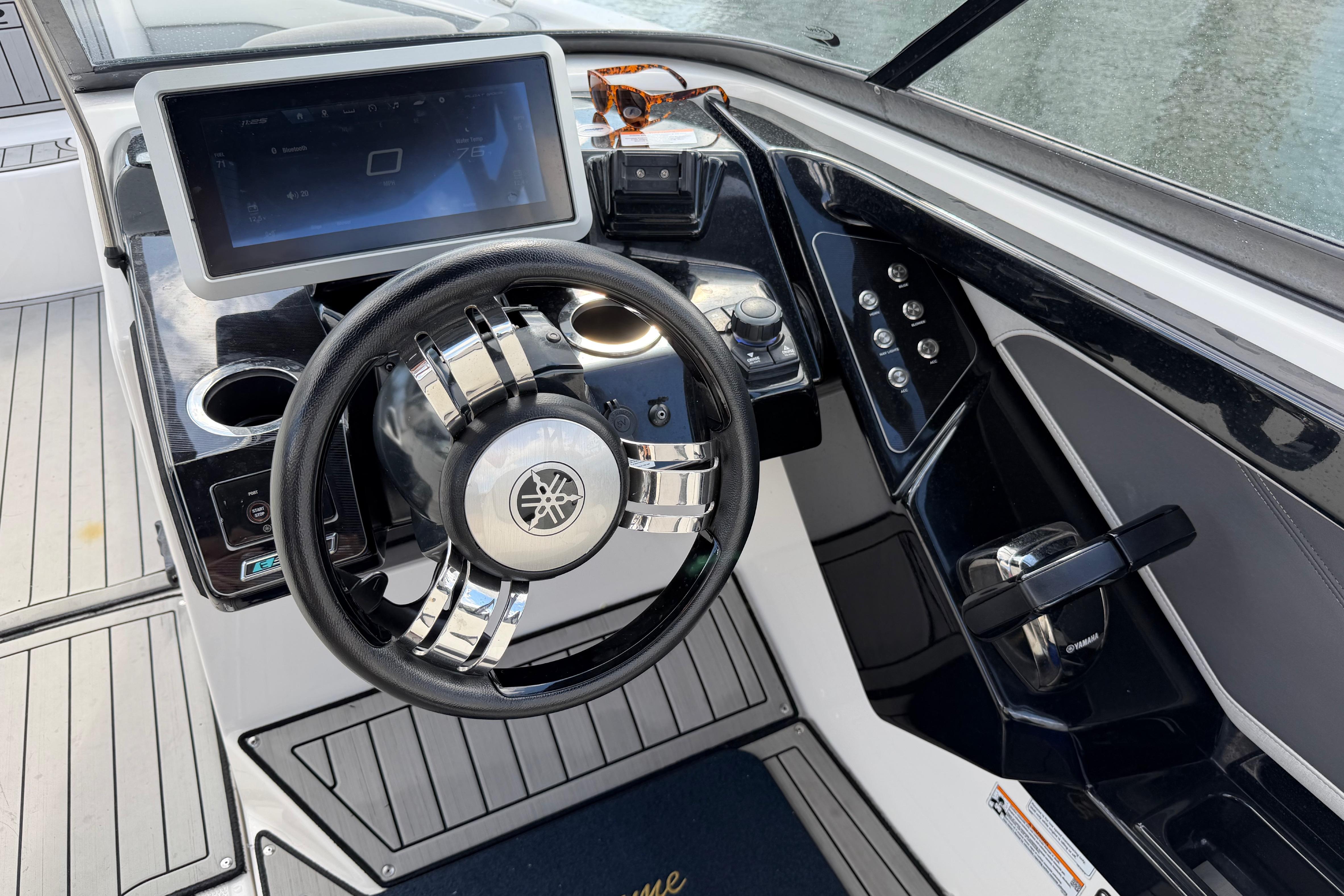 2022 Yamaha Boats 252SD dashboard with steering wheel and touchscreen display.