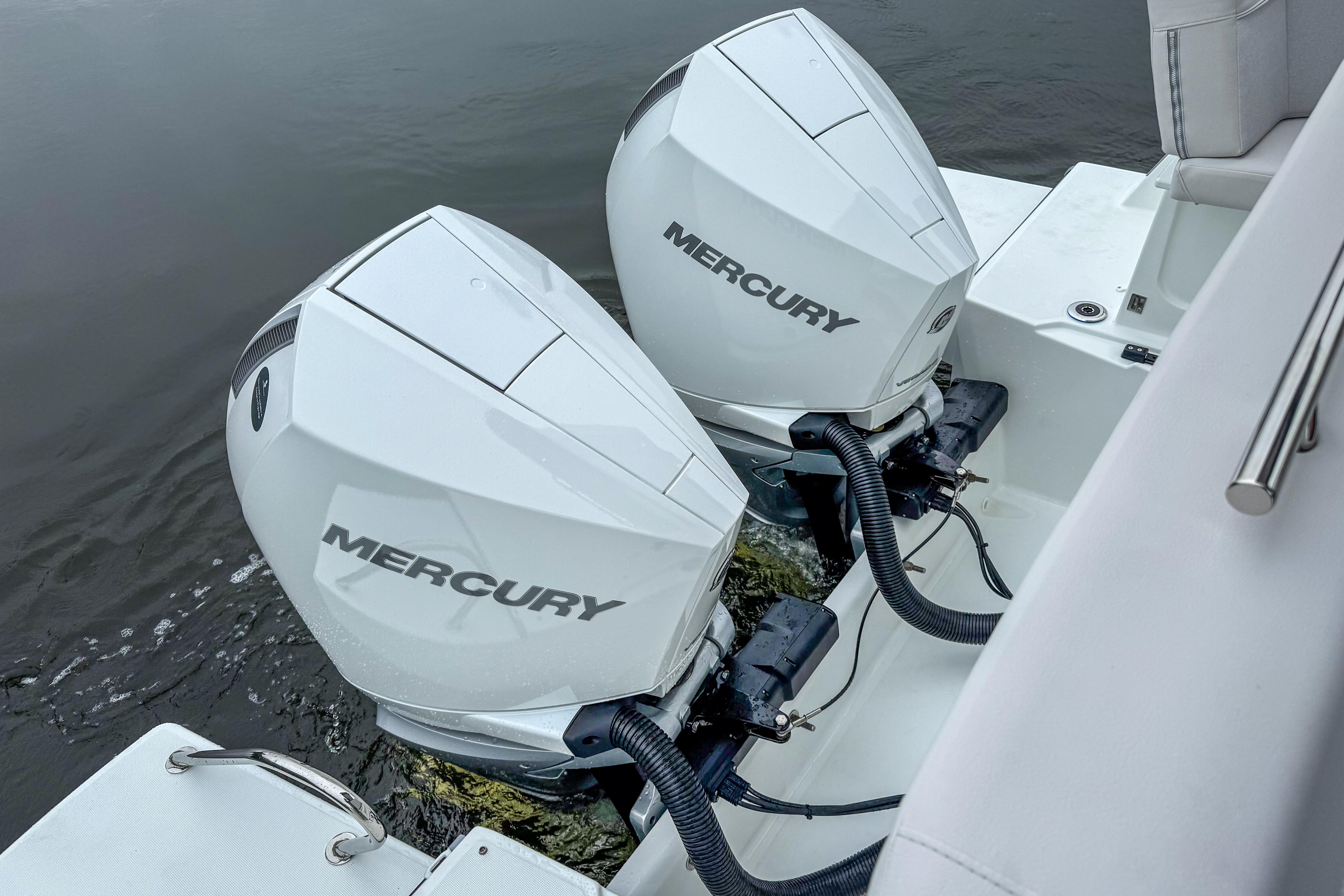 Twin Mercury outboard engines on a 2026 Beneteau Antares 11 boat, docked on water.