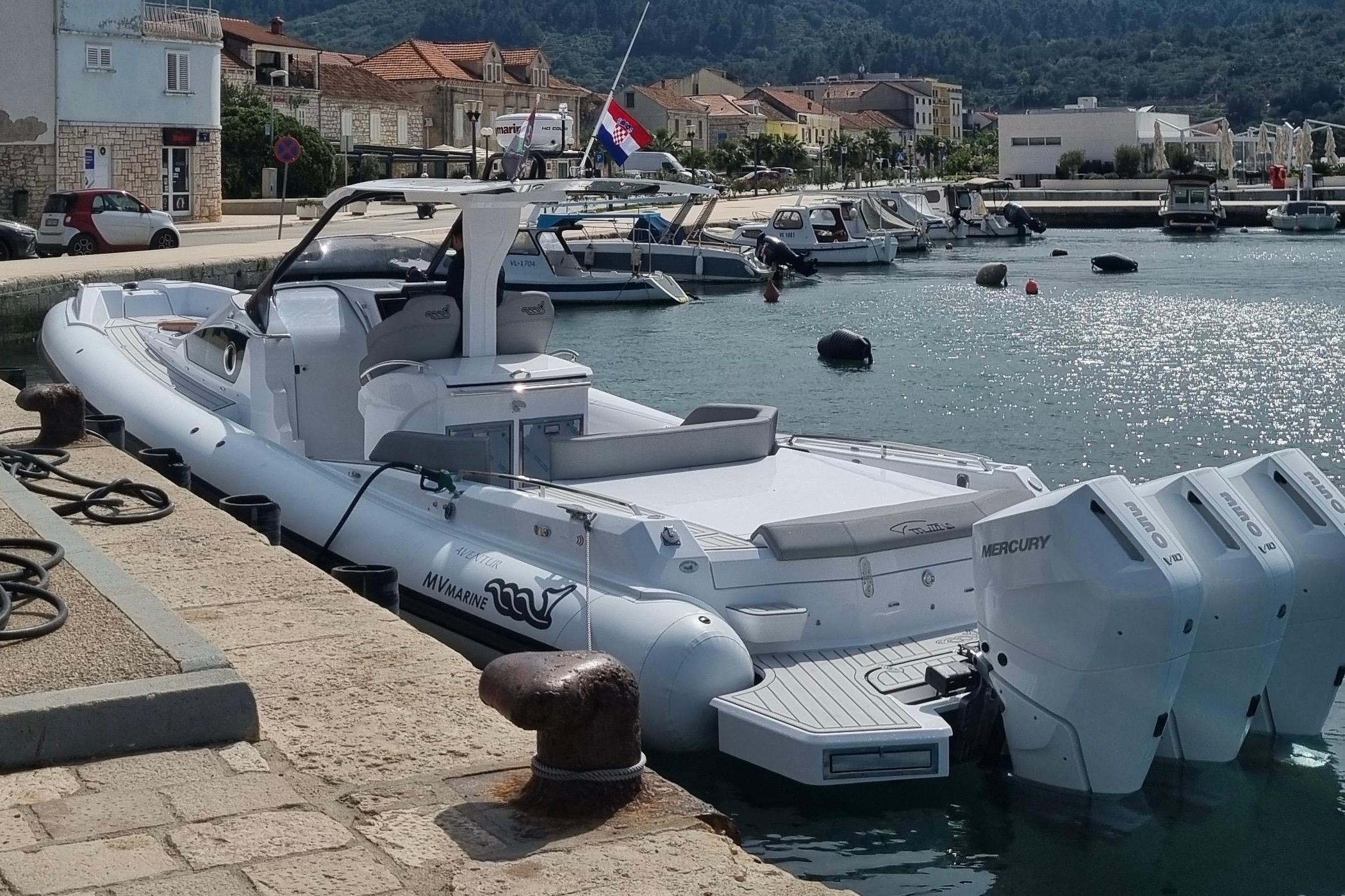 2024 MV Marine Mito 40 boat docked at a scenic marina with multiple engines.