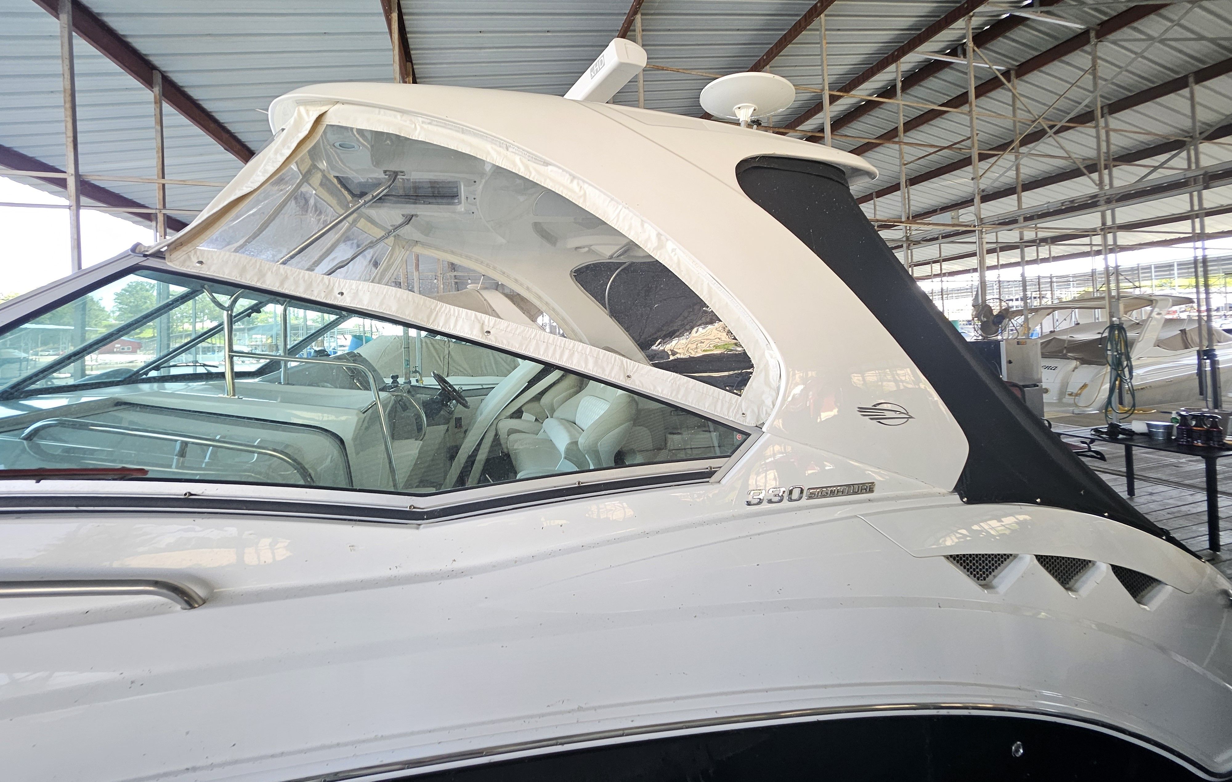 2014 Chaparral 330 Signature Yacht in covered marina.