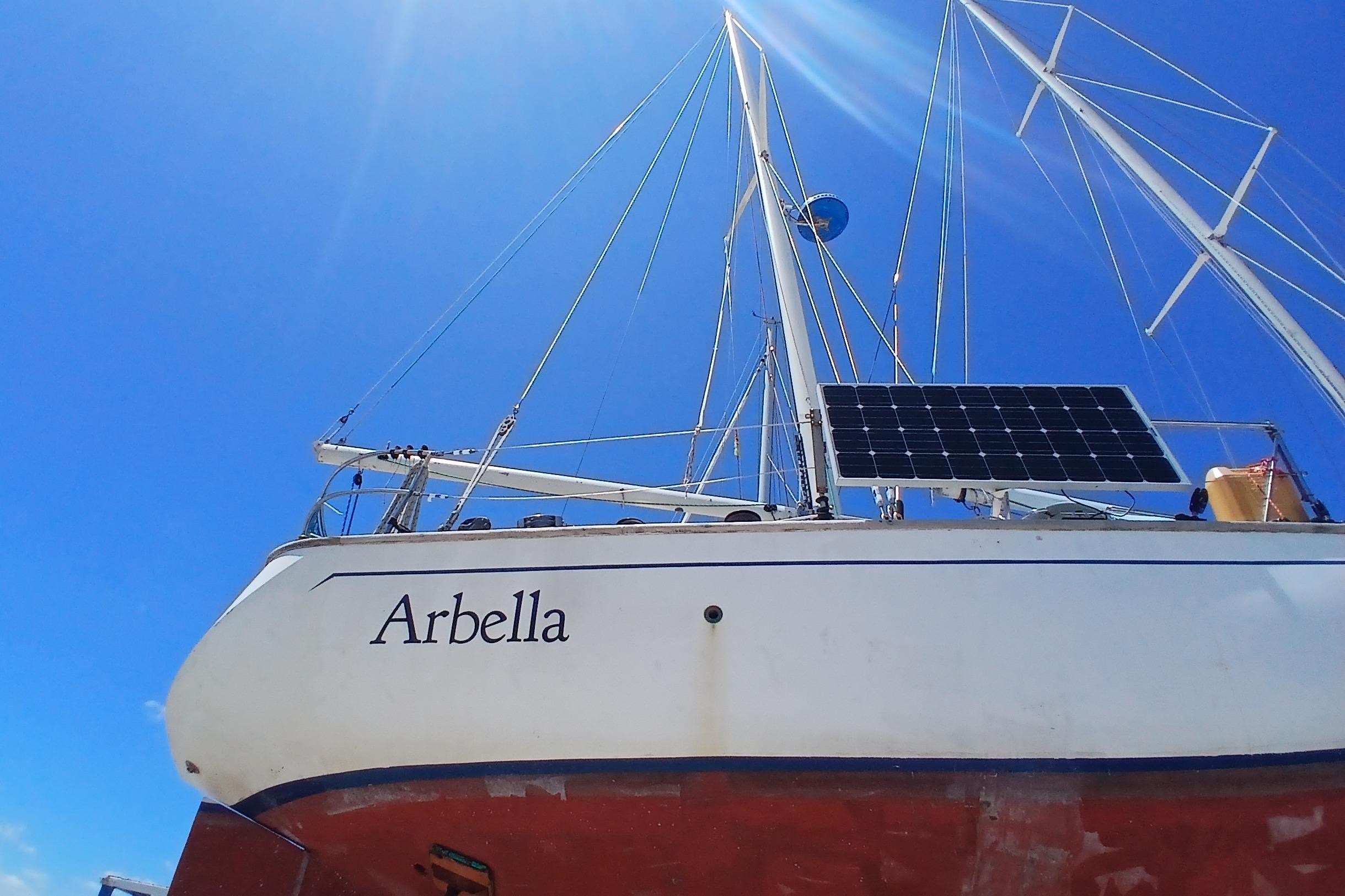 Sailboat "Arbella" with solar panel, Kaufman Skye 51, 1981, under clear blue sky.