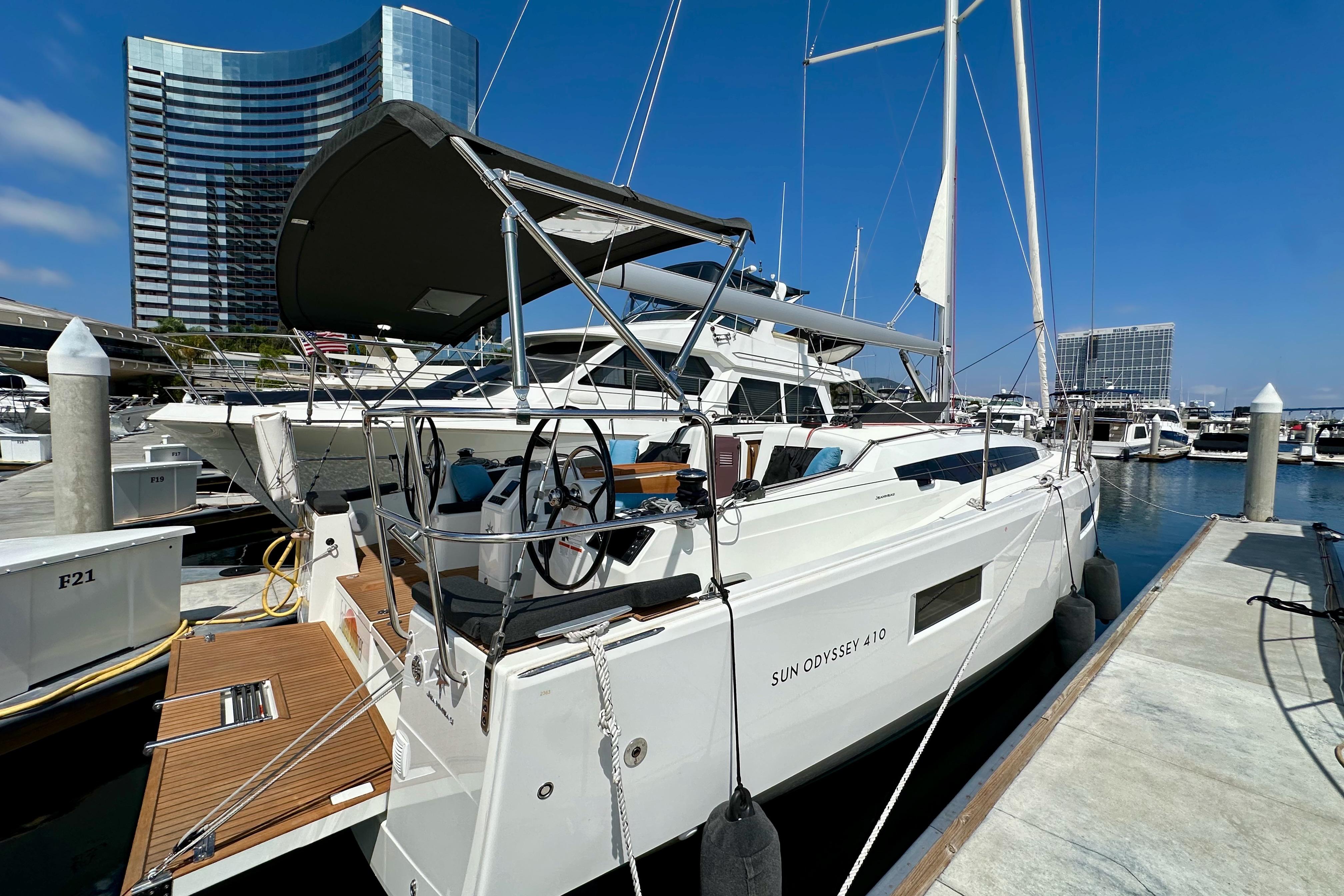 2024 Jeanneau Sun Odyssey 410 sailboat docked at marina, modern design, clear blue sky.