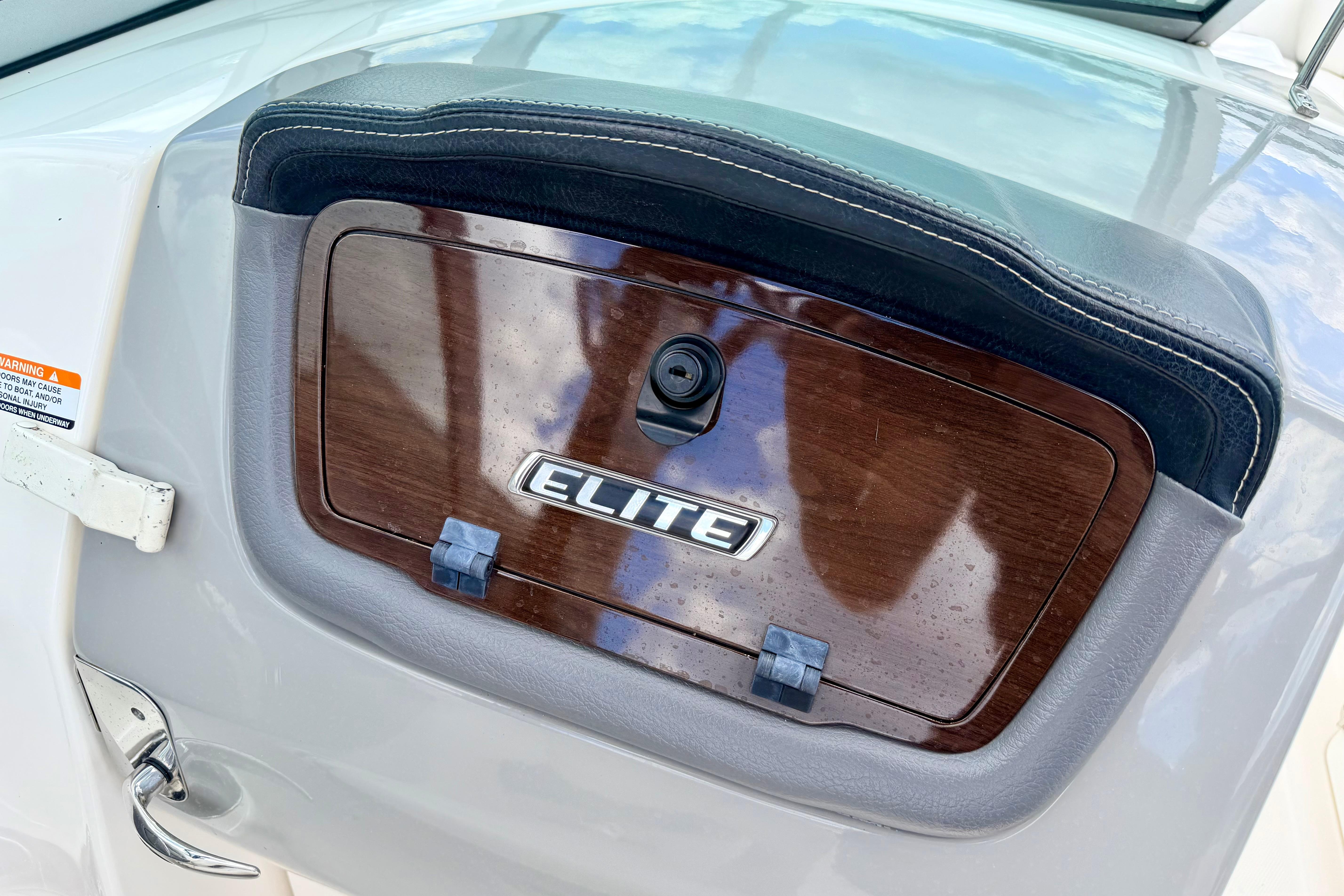 2015 Chaparral Sunesta 264 boat dashboard with Elite emblem and wood finish.