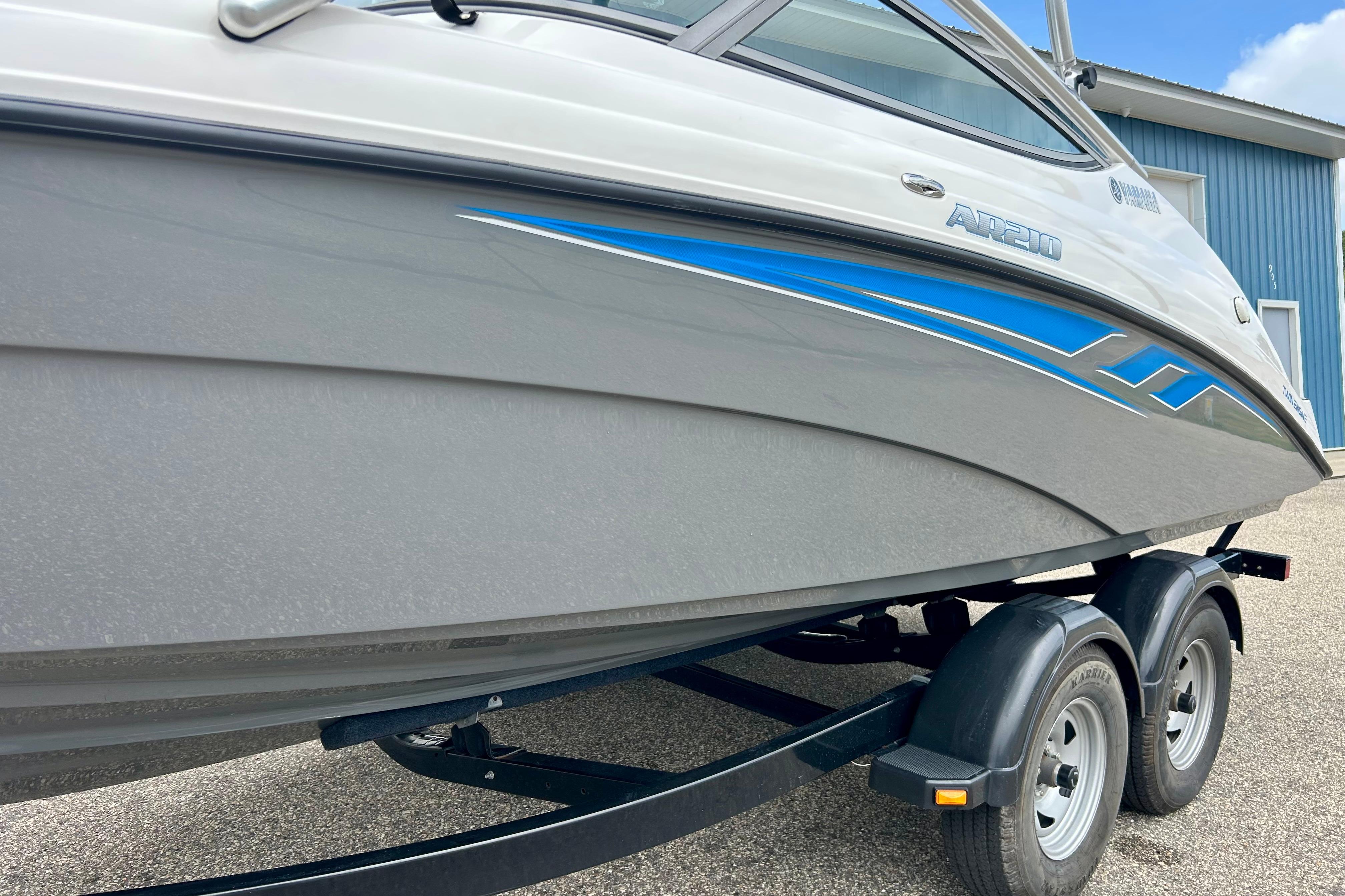 2015 Yamaha AR210 boat on trailer, featuring sleek design and blue accents.