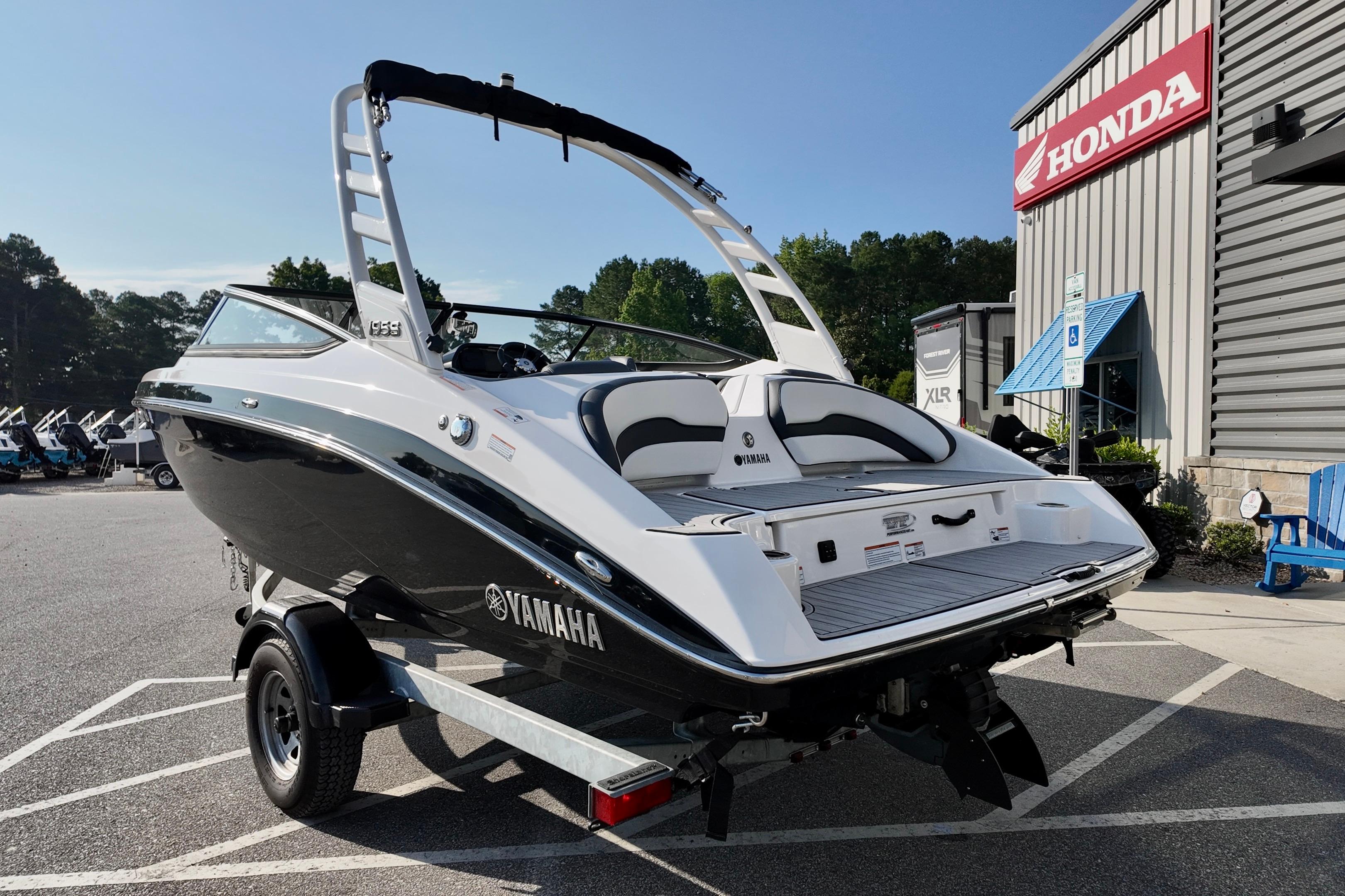 2023 Yamaha 195S boat on trailer, parked outside a Honda dealership.