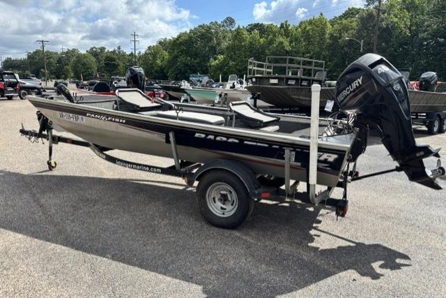 2015 Tracker Panfish 16 boat on trailer, parked outdoors under a cloudy sky.