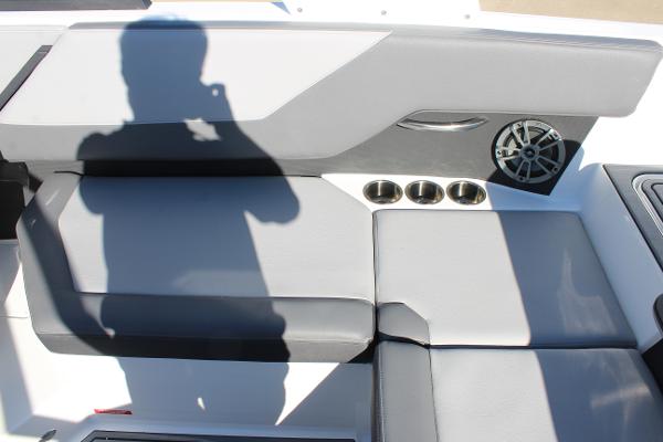 2025 Cobalt CS23 boat interior with gray seating, cup holders, and speaker.