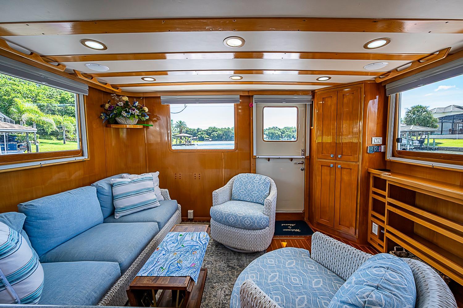 Luxurious interior of 2003 Magna Marine Nova Scotia 47 yacht with plush seating and wooden accents.