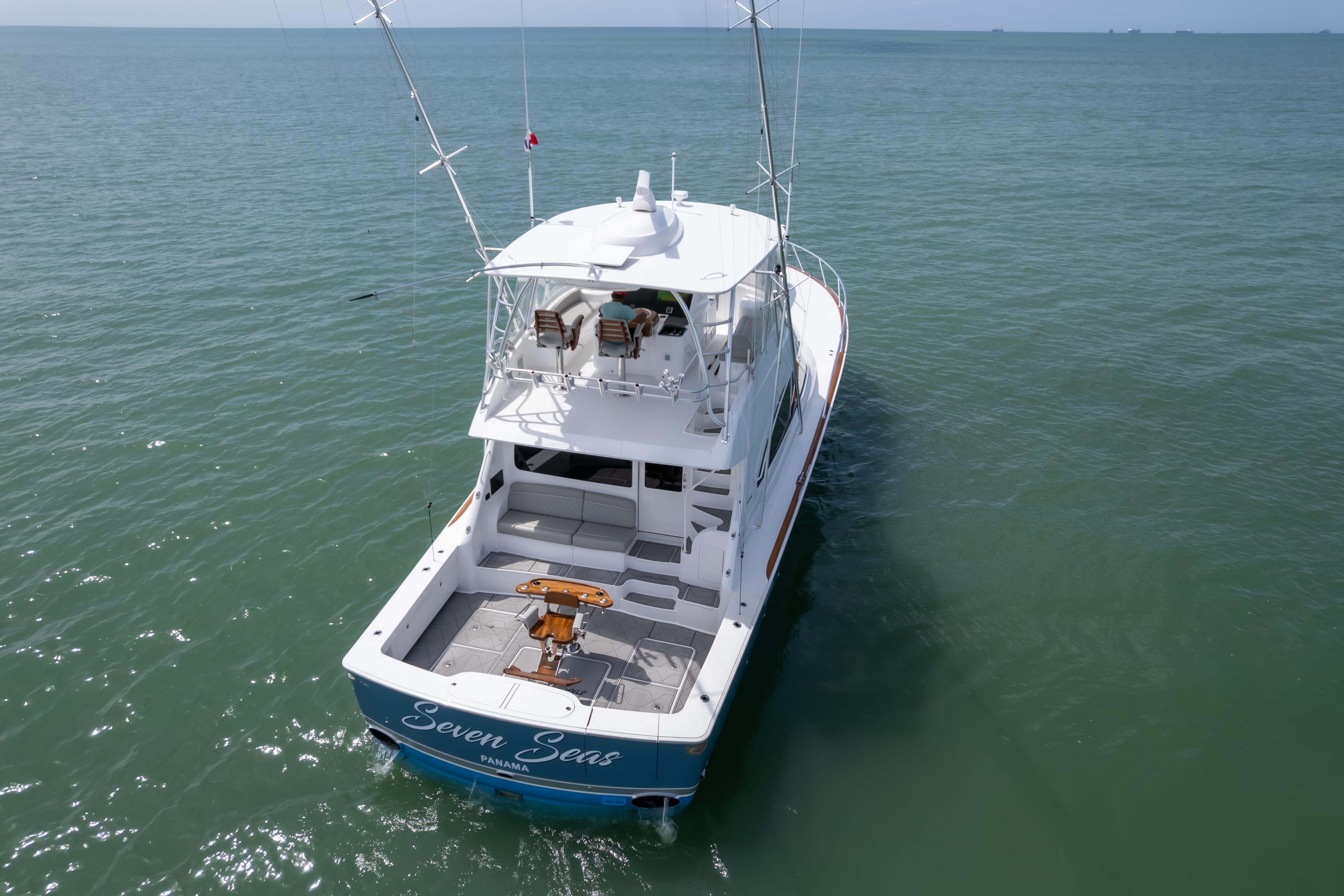 2024 Viking 58 Convertible yacht on open sea, rear view, named "Seven Seas".