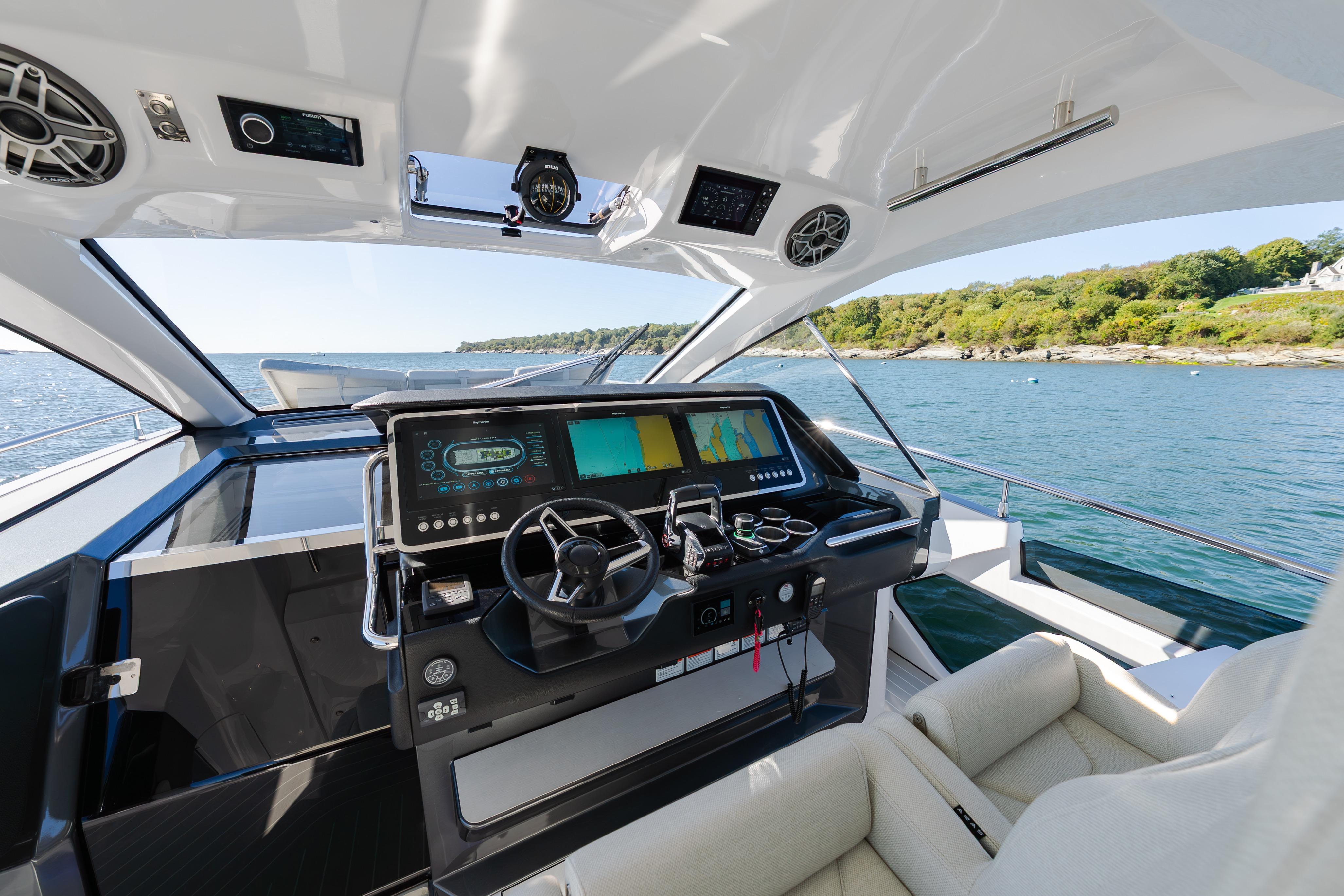 Cockpit of 2023 Azimut Verve 47 yacht with advanced navigation system and scenic ocean view.