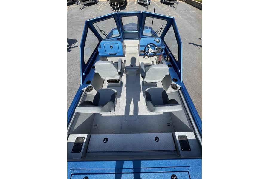 2026 SeaArk Dynasty 2.0 boat interior with blue dashboard and seating arrangement.