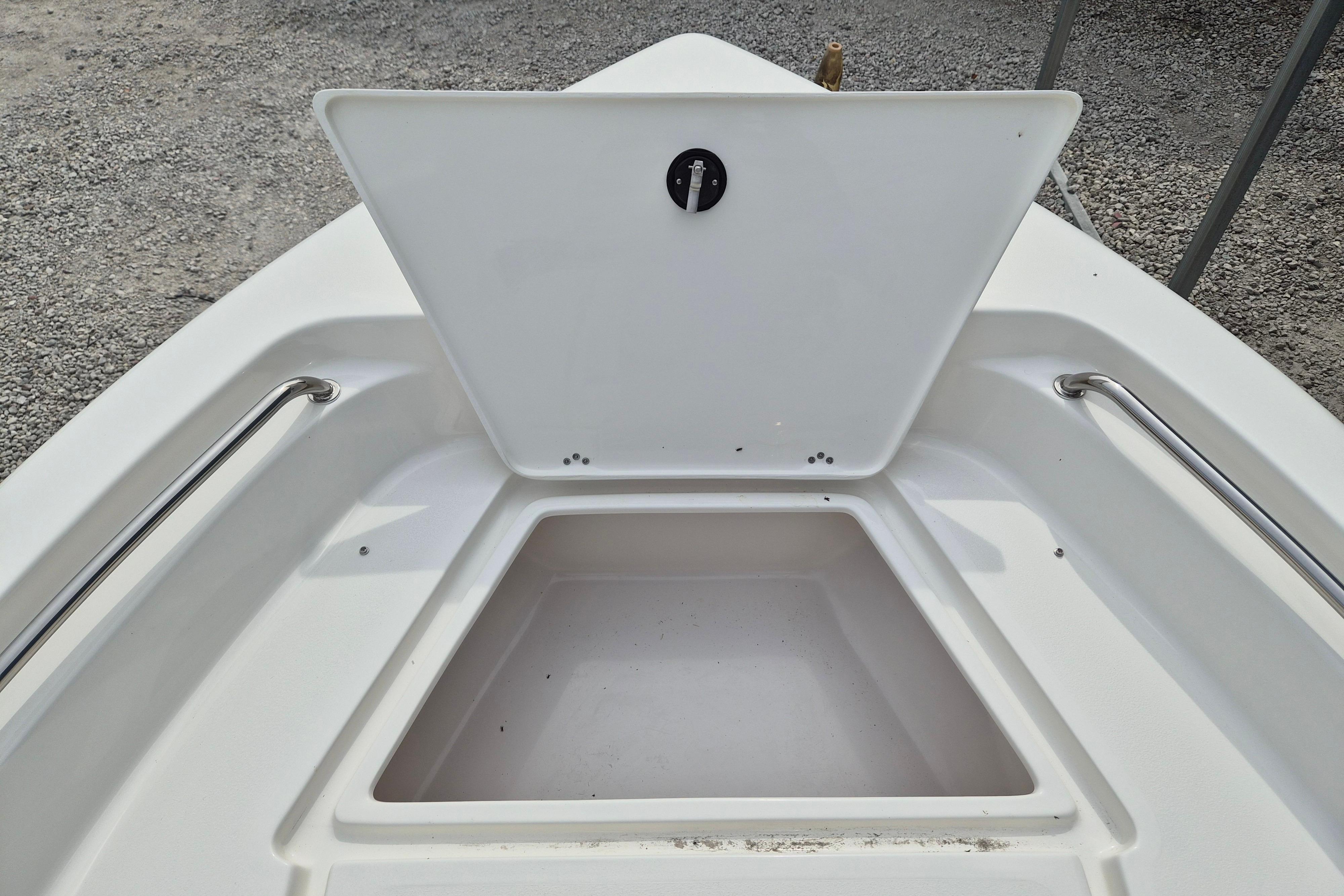 Open storage compartment on 2026 Key West 189 FS boat, featuring stainless steel rails.