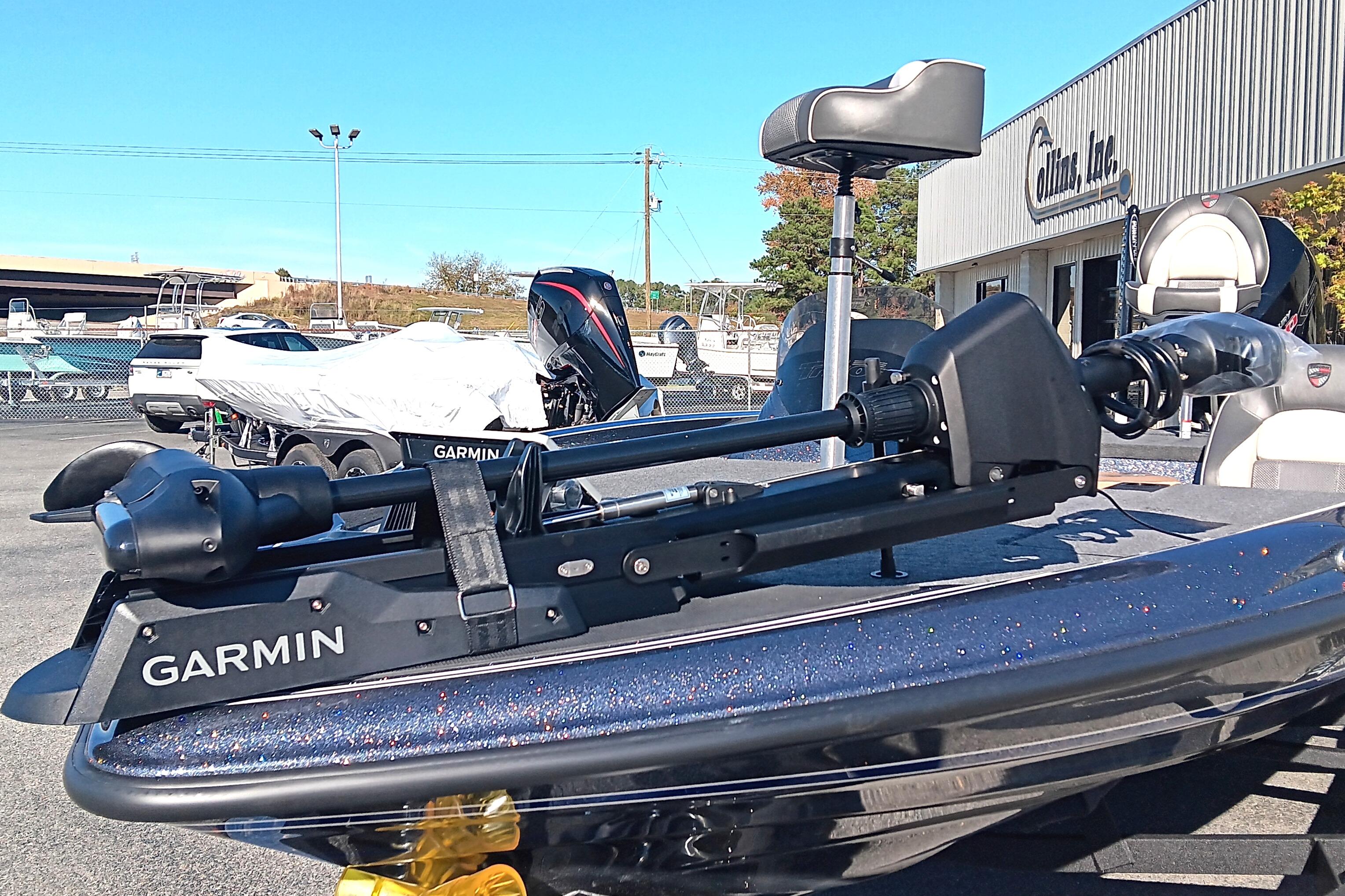 2026 Triton 18 TrX boat with Garmin trolling motor in a dealership lot.