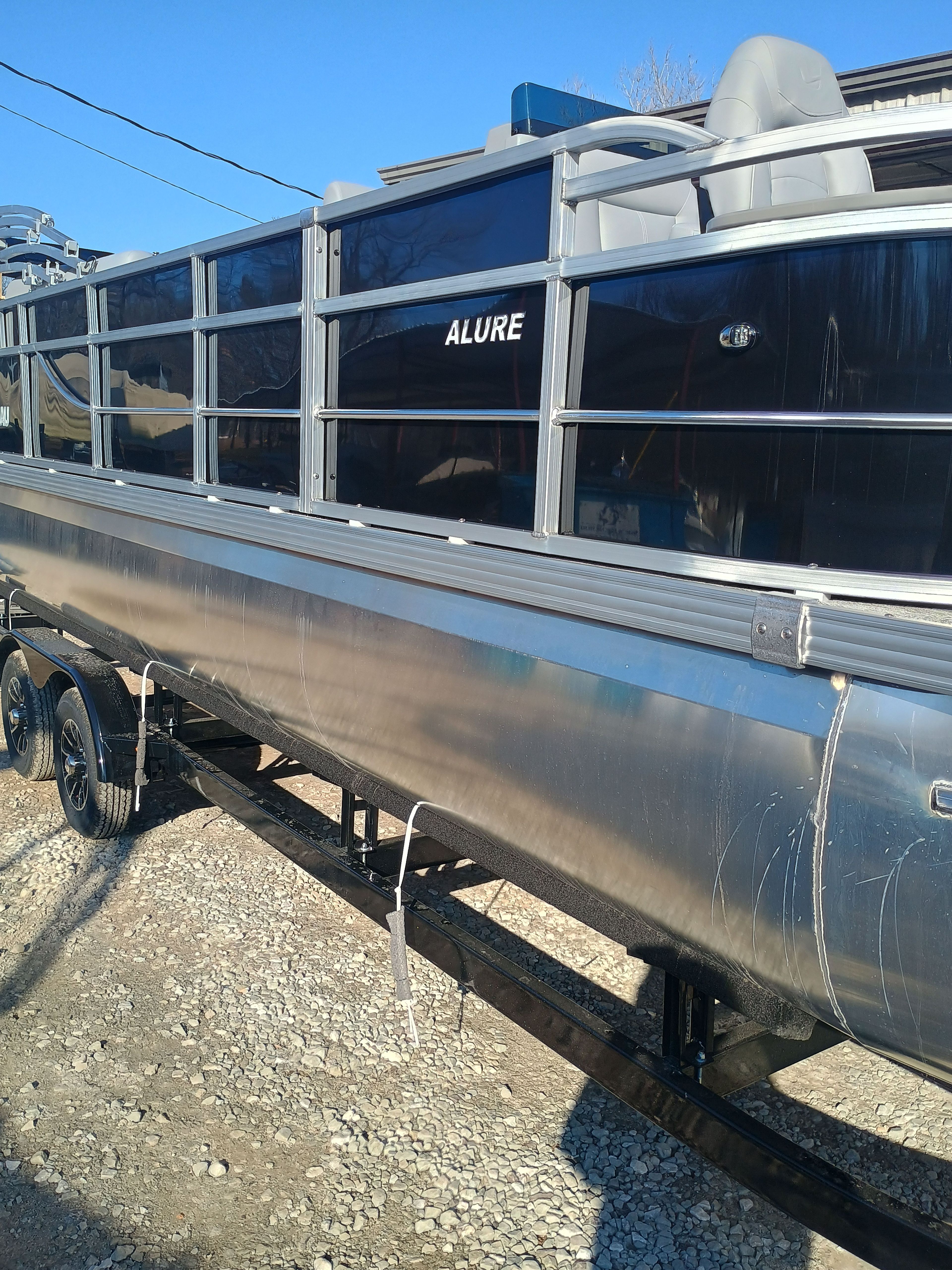 2026 Landau Alure 25CC Fish-Black boat on trailer, side view.