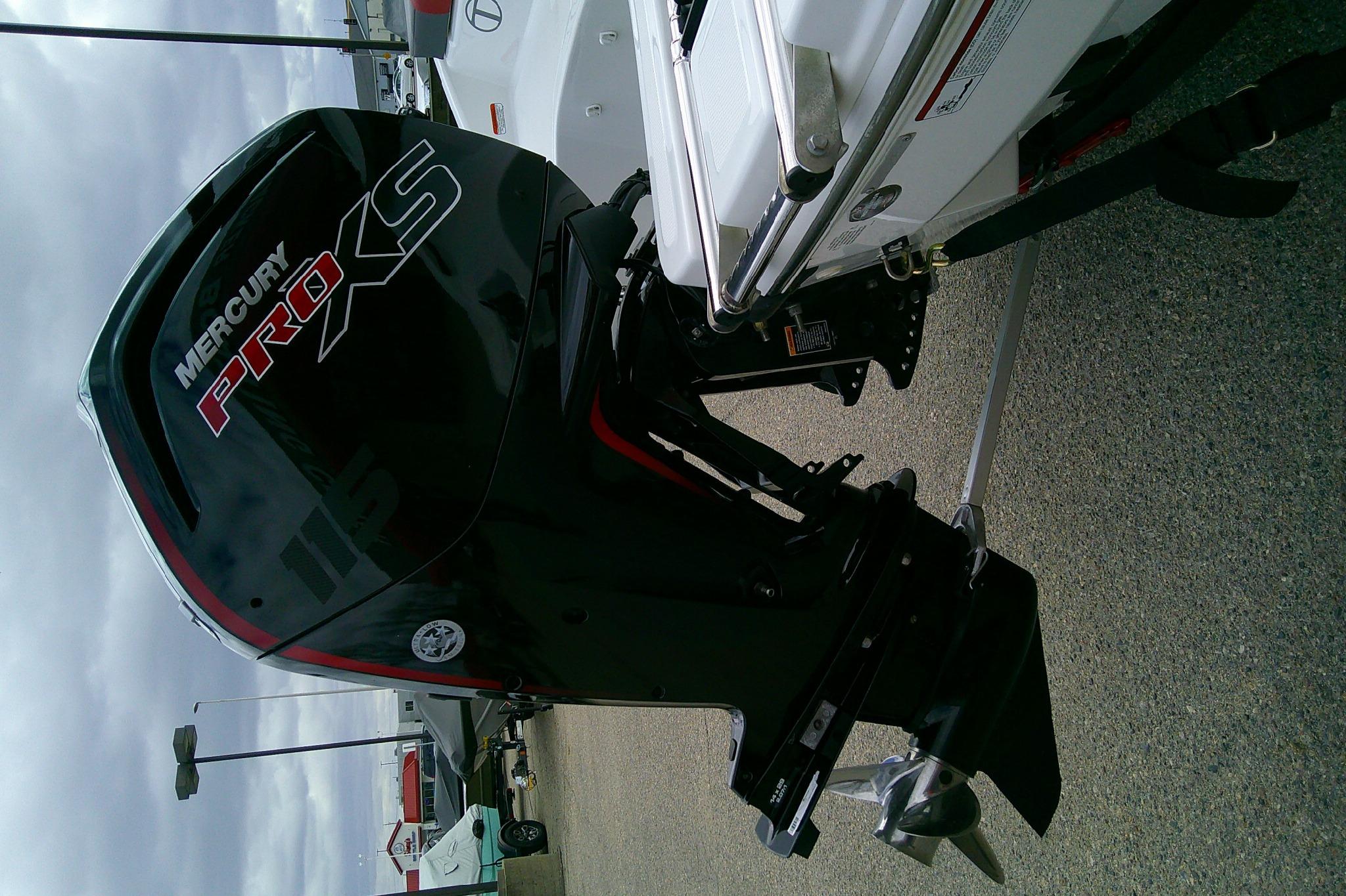 2024 Tahoe T18 boat with Mercury Pro XS outboard motor, parked on pavement.