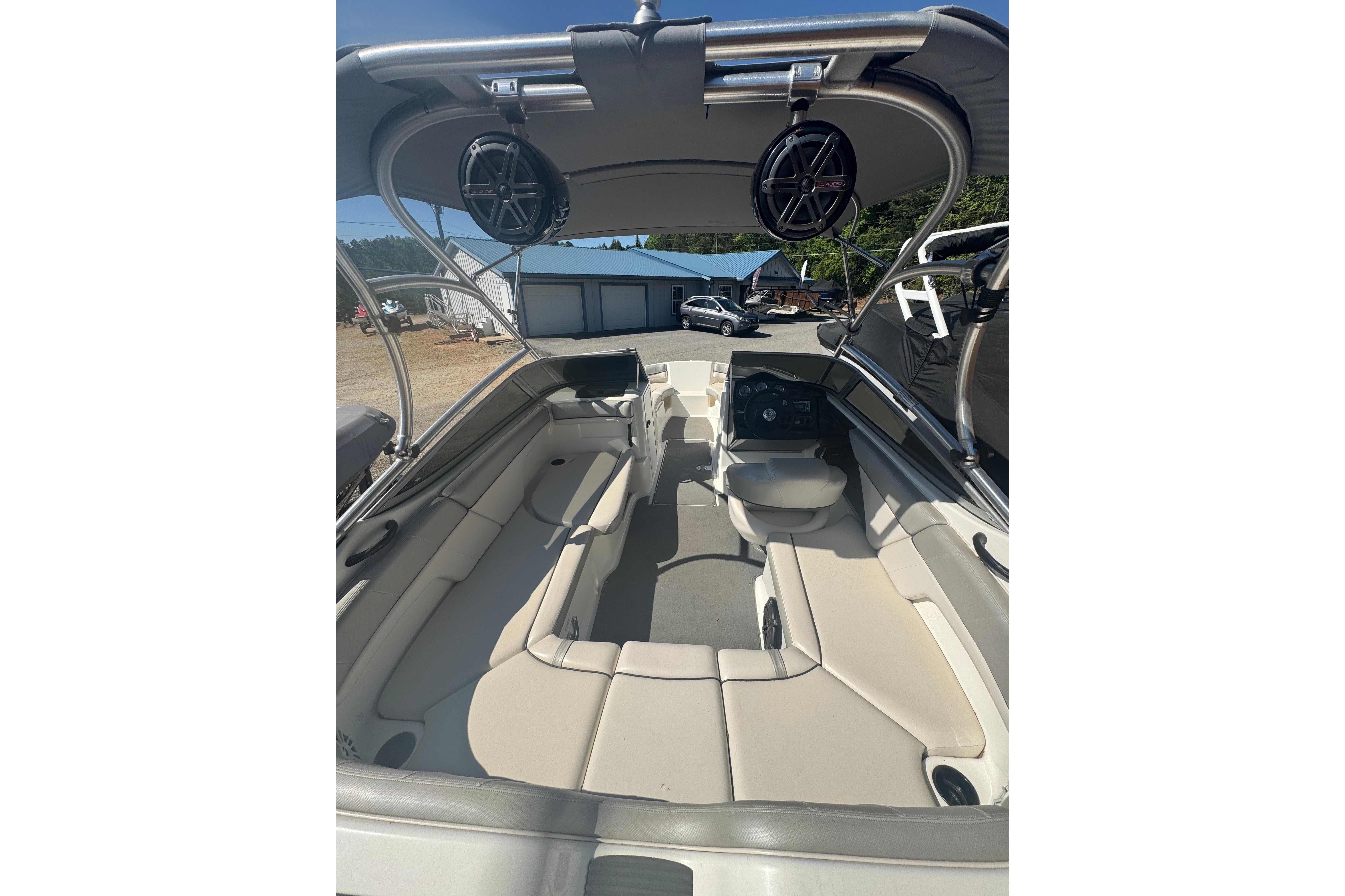 2012 Yamaha AR210 boat interior with seating and speakers, parked outdoors.