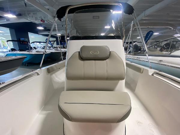 2024 Key West 189 FS boat interior with cushioned seating in showroom.
