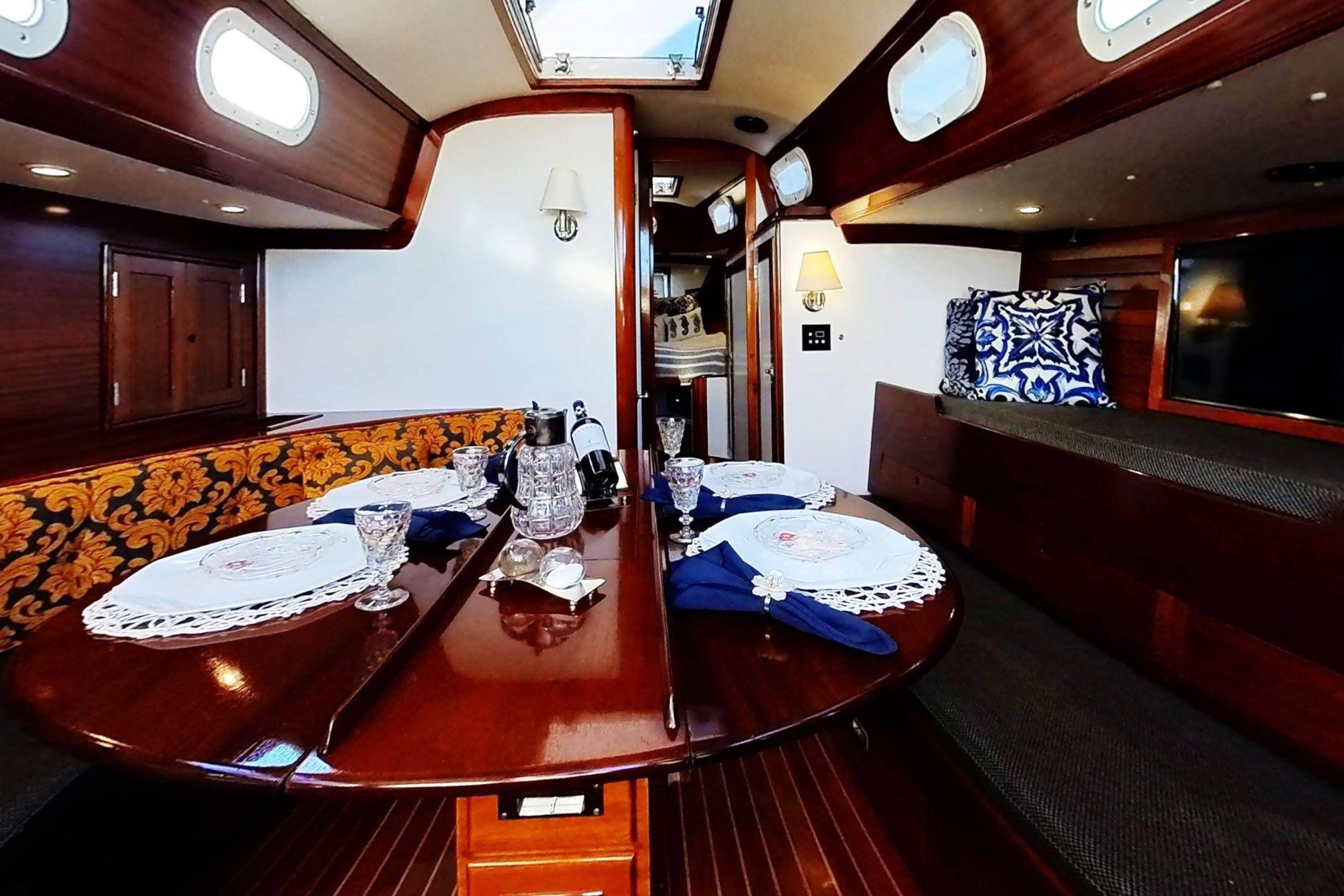 Luxurious interior of a 1970 Hinckley Bermuda 40 yacht with elegant dining setup.
