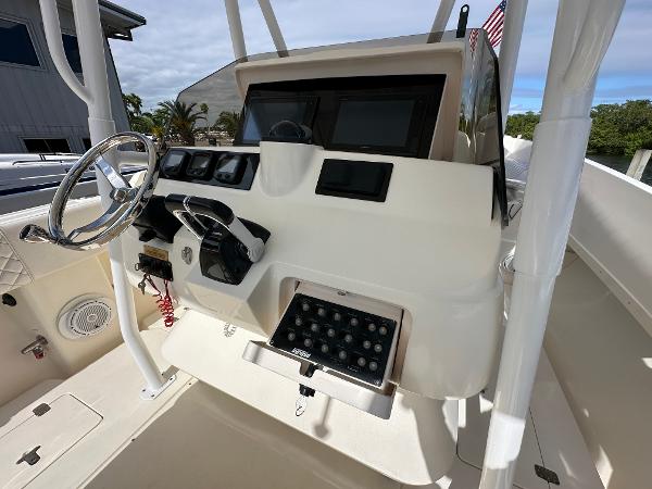 2005 Intrepid 323 boat dashboard with steering wheel and control panel.