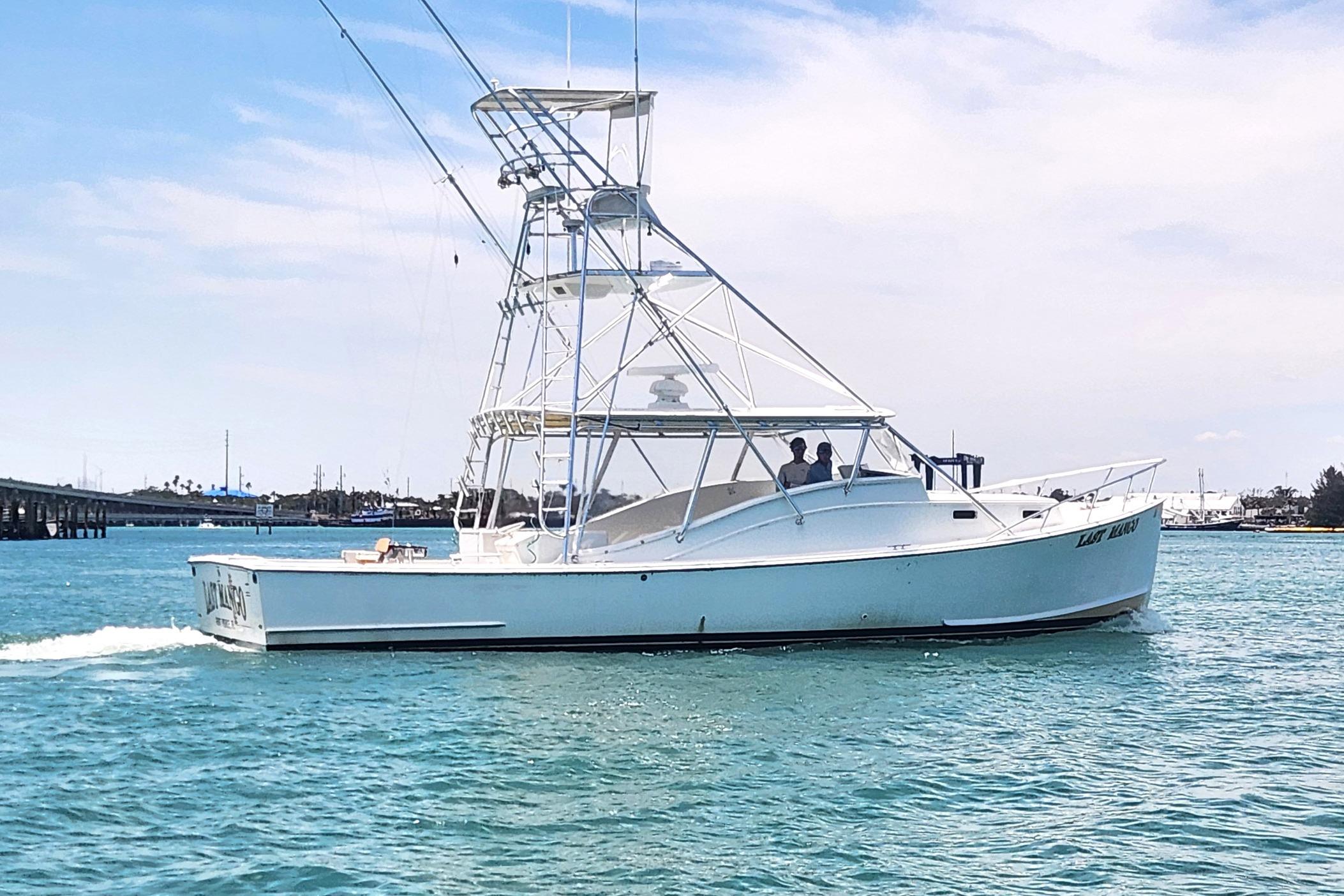 1987 Young Brothers Custom Sport Fish boat cruising on clear blue water.