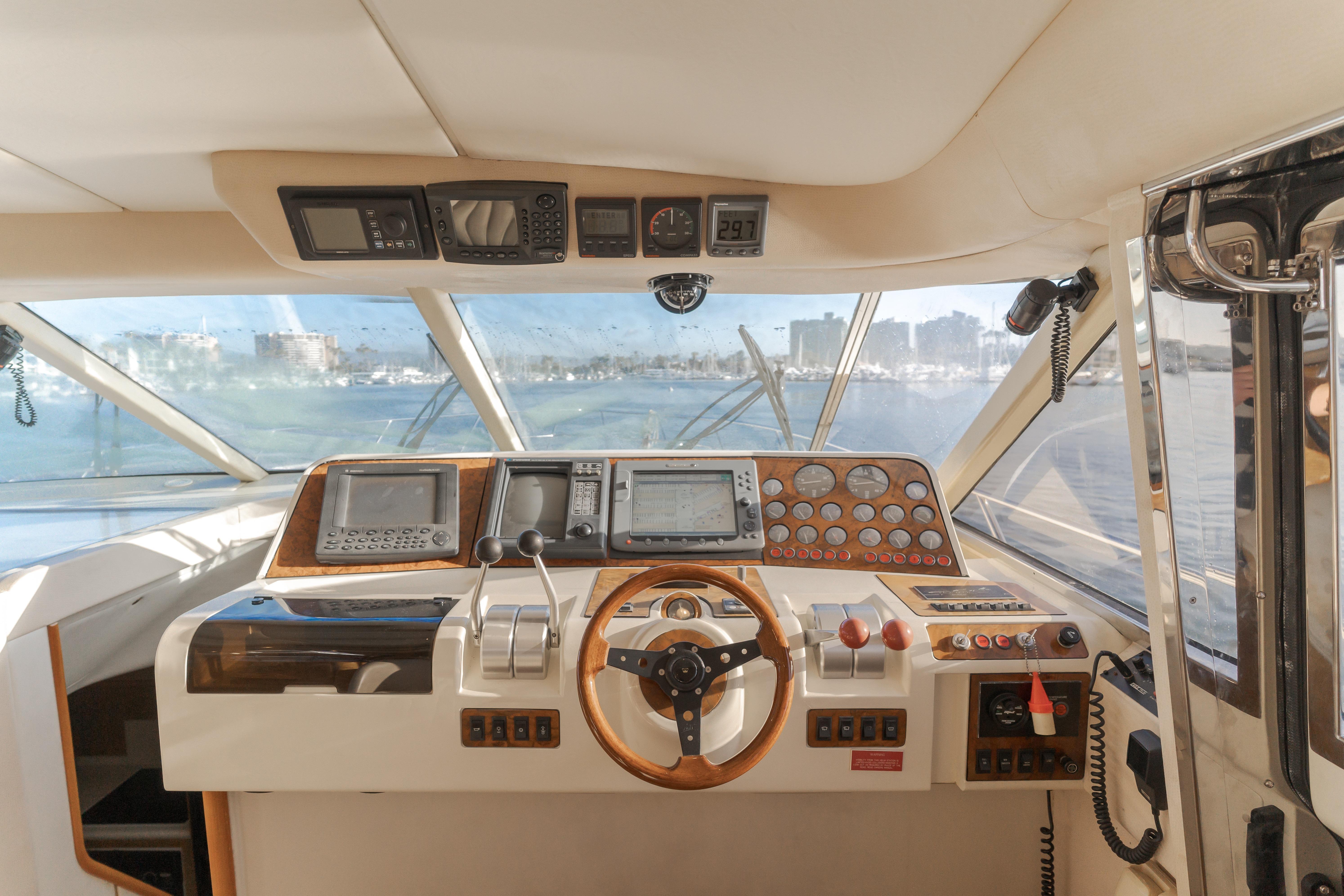 Cockpit of 1997 Viking Sport Cruisers 66 Motor Yacht with navigation instruments and steering wheel.