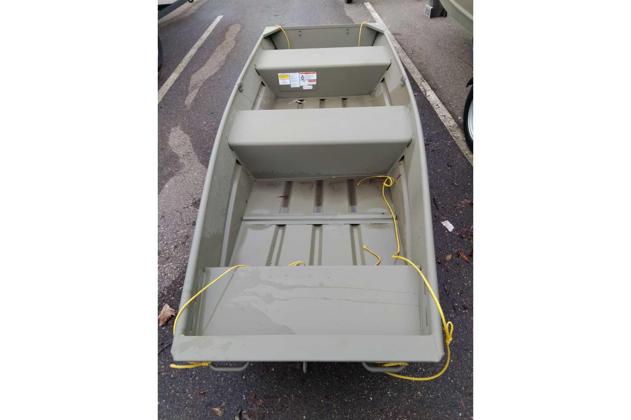 2026 Tracker Grizzly 12 Jon boat, parked on asphalt, featuring a simple, durable design.