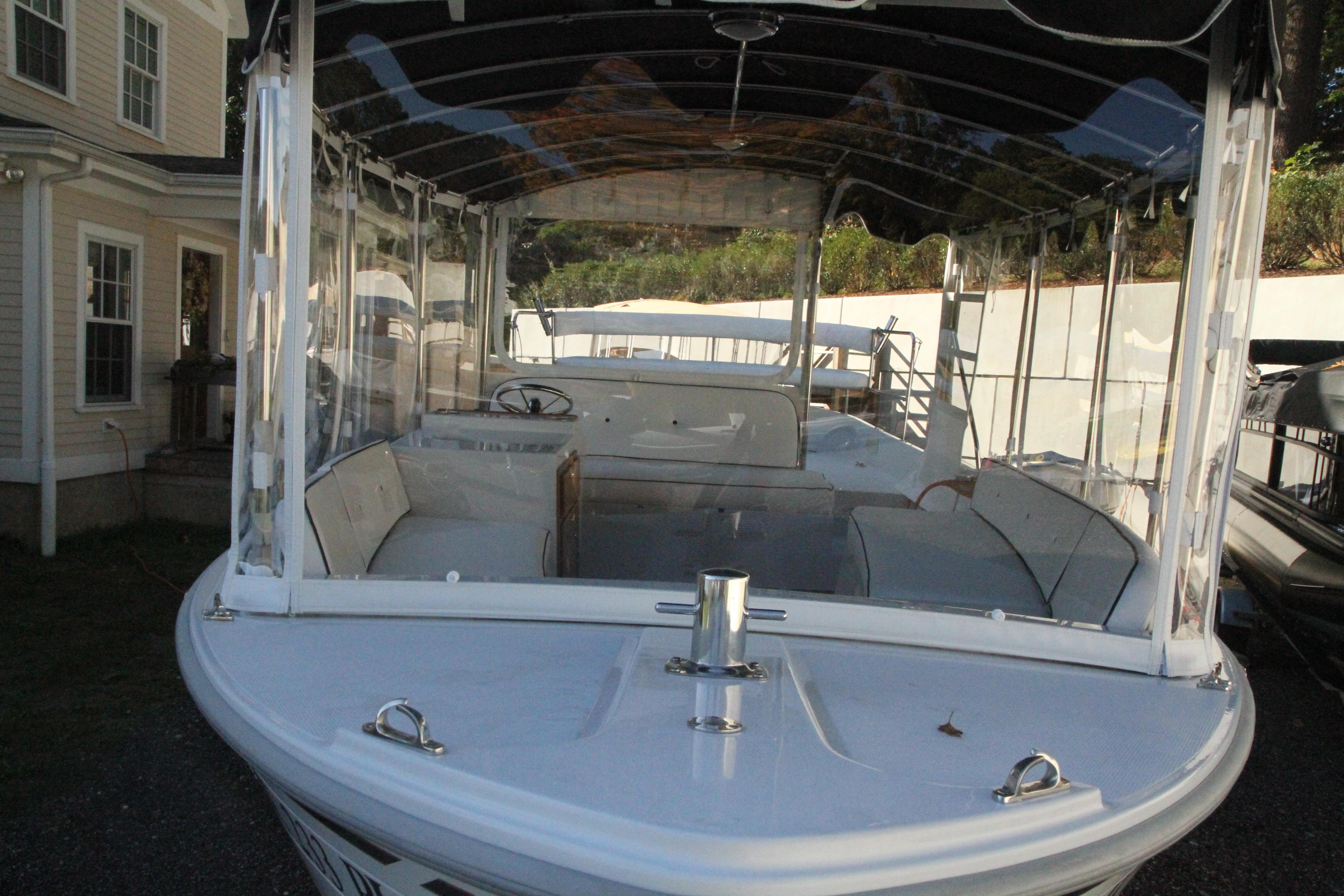 2020 Duffy Suncruiser 22 electric boat with spacious seating and clear canopy.