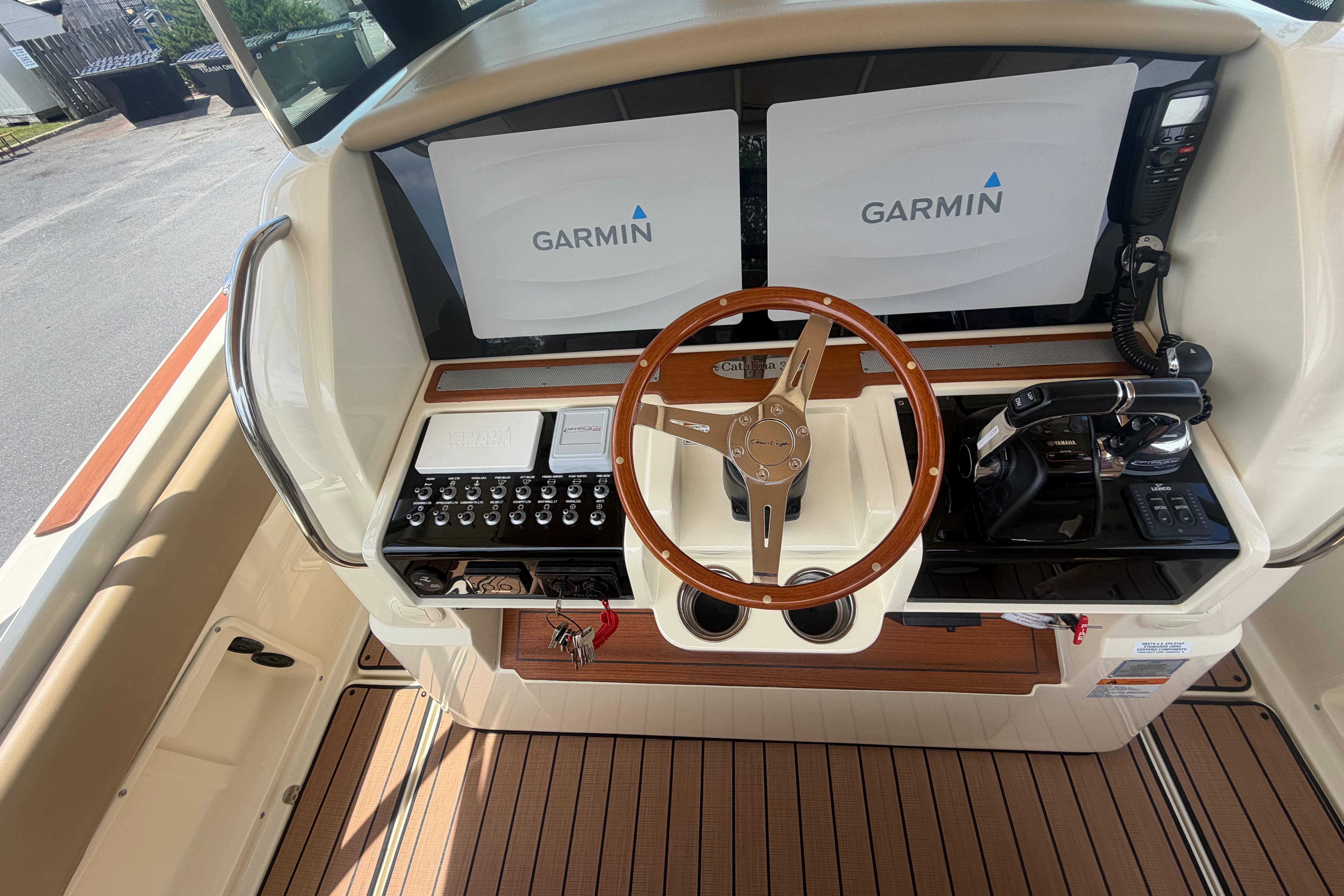 2017 Chris-Craft Catalina 34 helm with Garmin displays and wooden steering wheel.