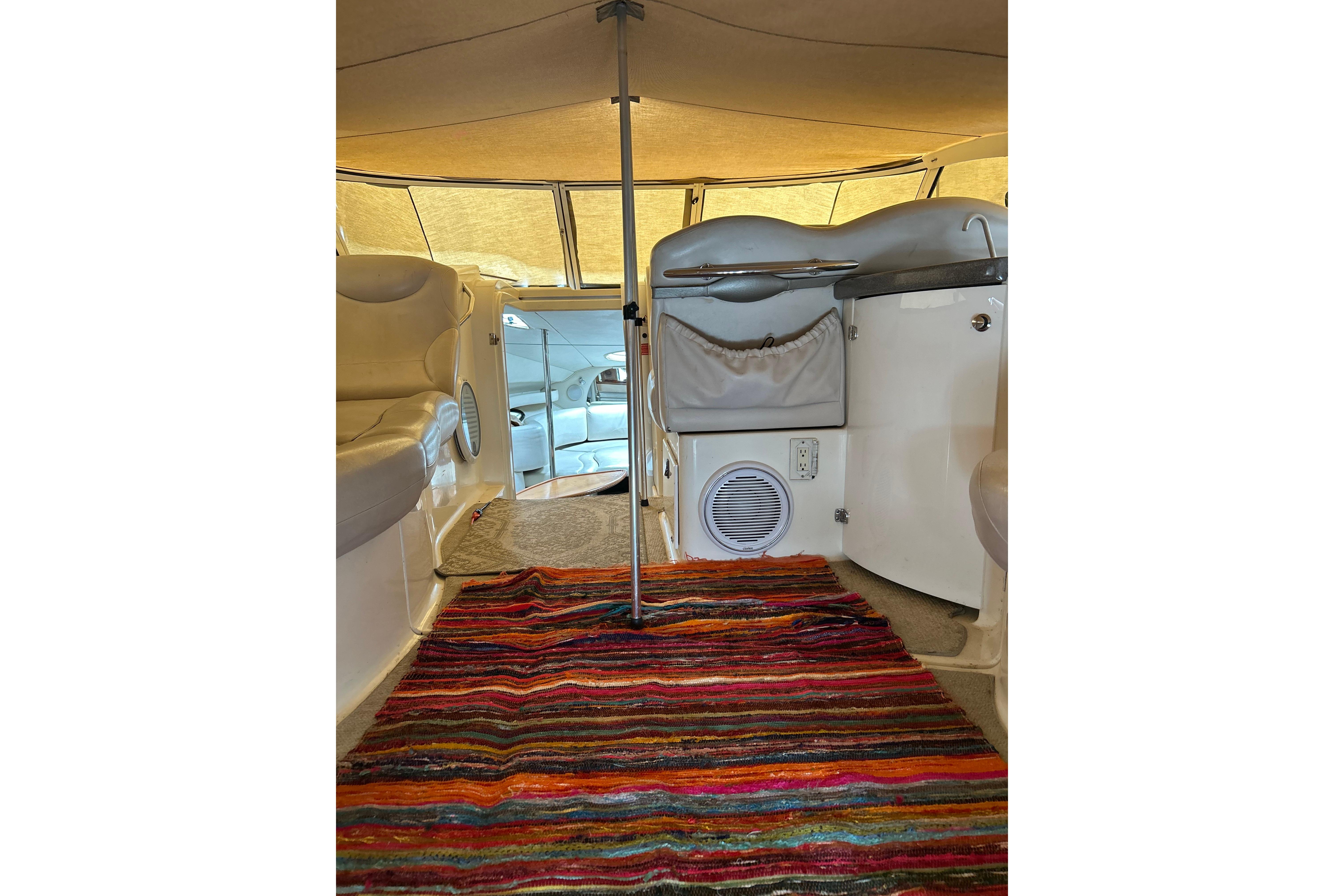 Interior of a 2001 Doral 330se boat with colorful striped rug.