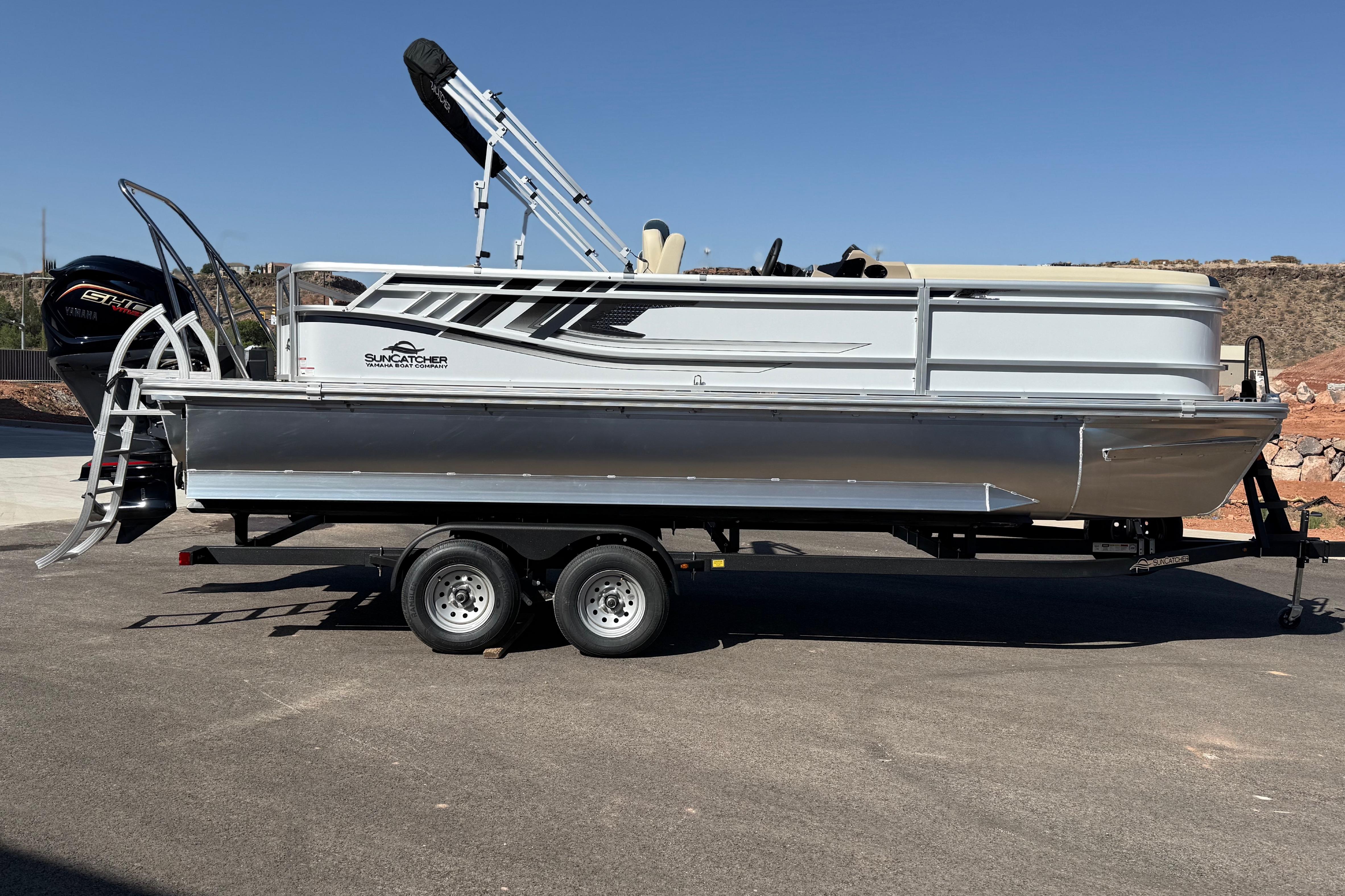 2026 SunCatcher Select 322SL pontoon boat on trailer, parked outdoors.