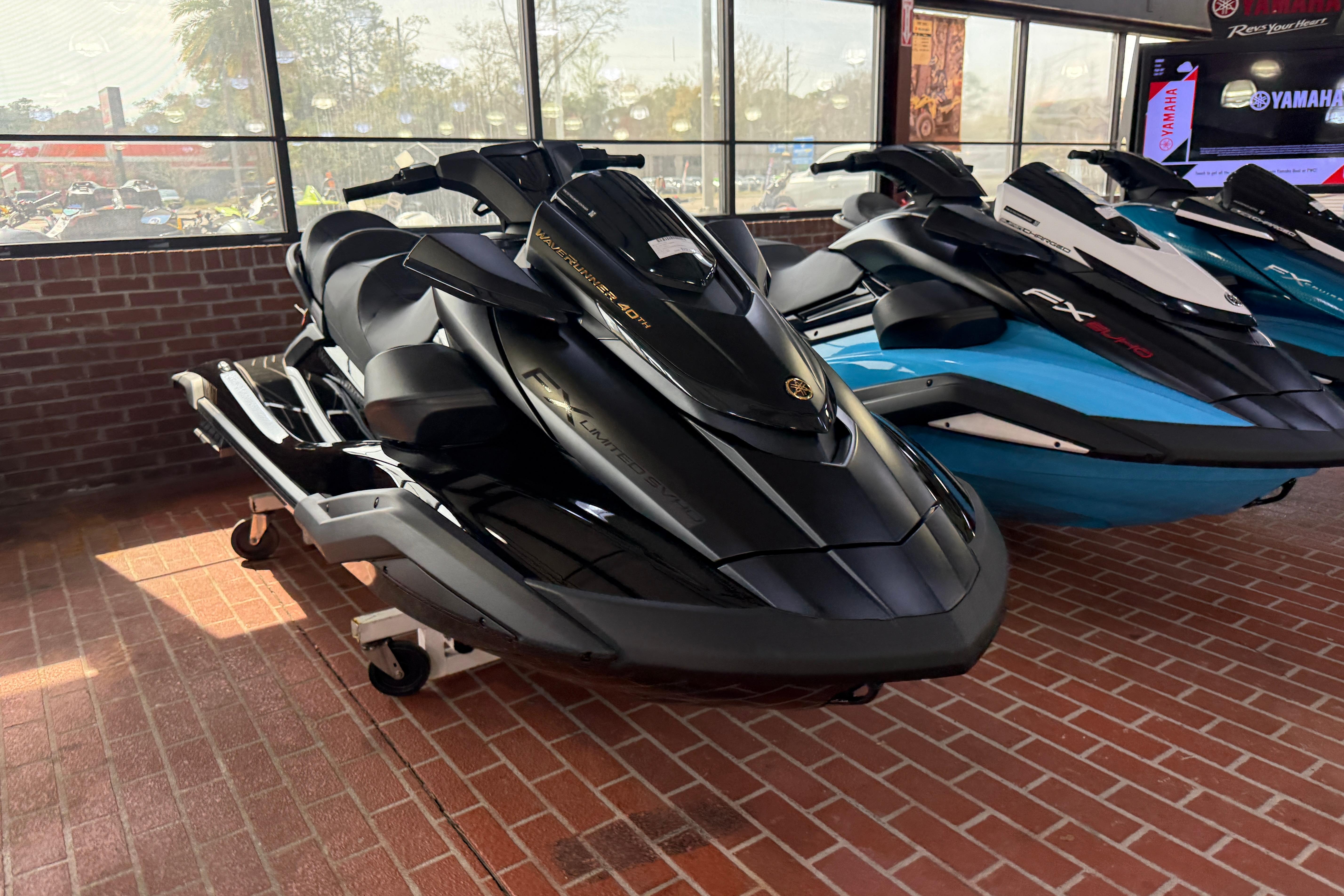 2026 Yamaha WaveRunner FX Limited SVHO in showroom, sleek black design, displayed indoors.